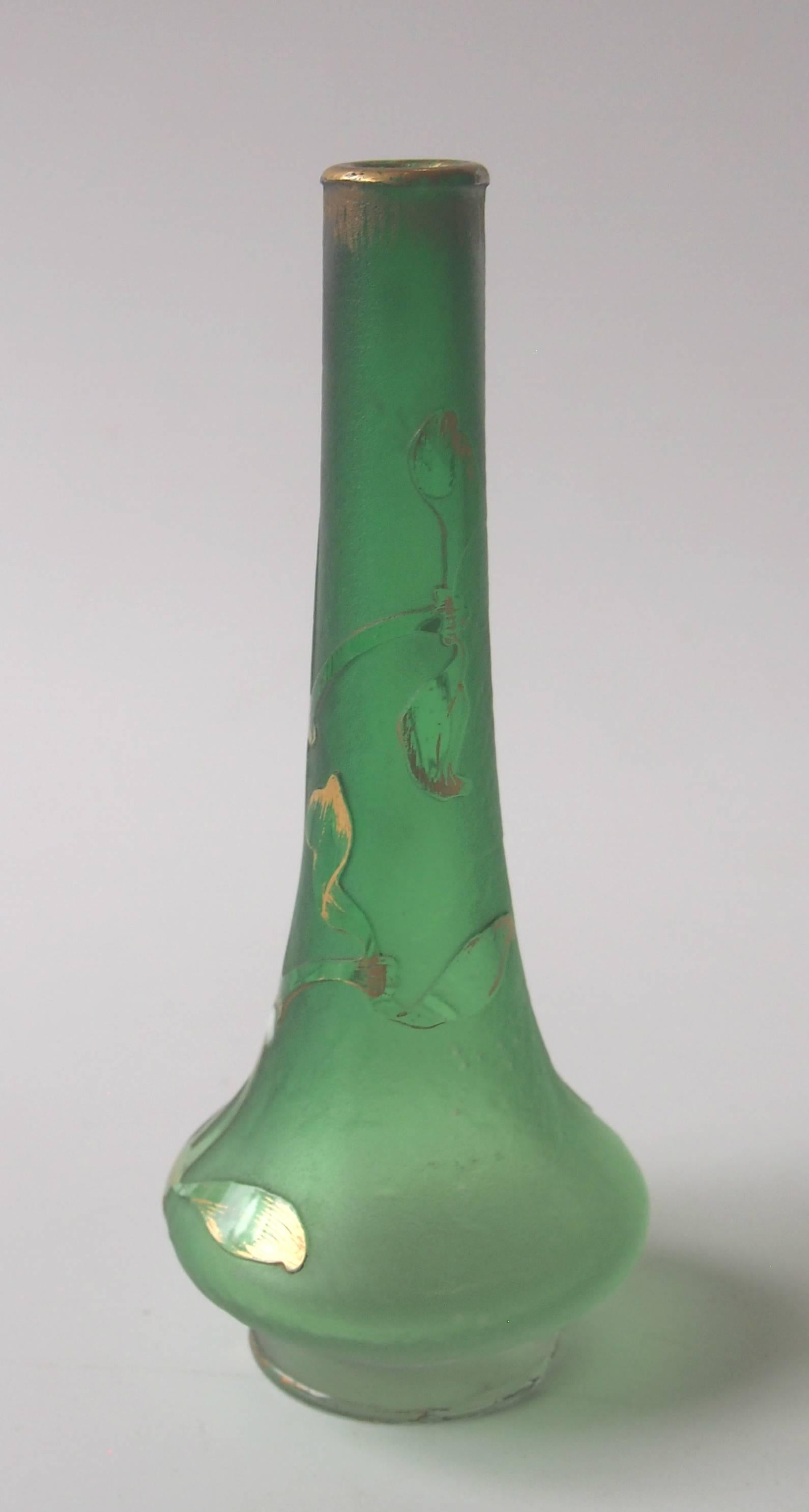 Small green to clear, gilded and applied raised enamel Daum Mistletoe vase, the mistletoe berries are enameled with raised white enamel. Signed 'Daum Nancy' to the base. Mistletoe was one of the most significant iconic Art Nouveau images.