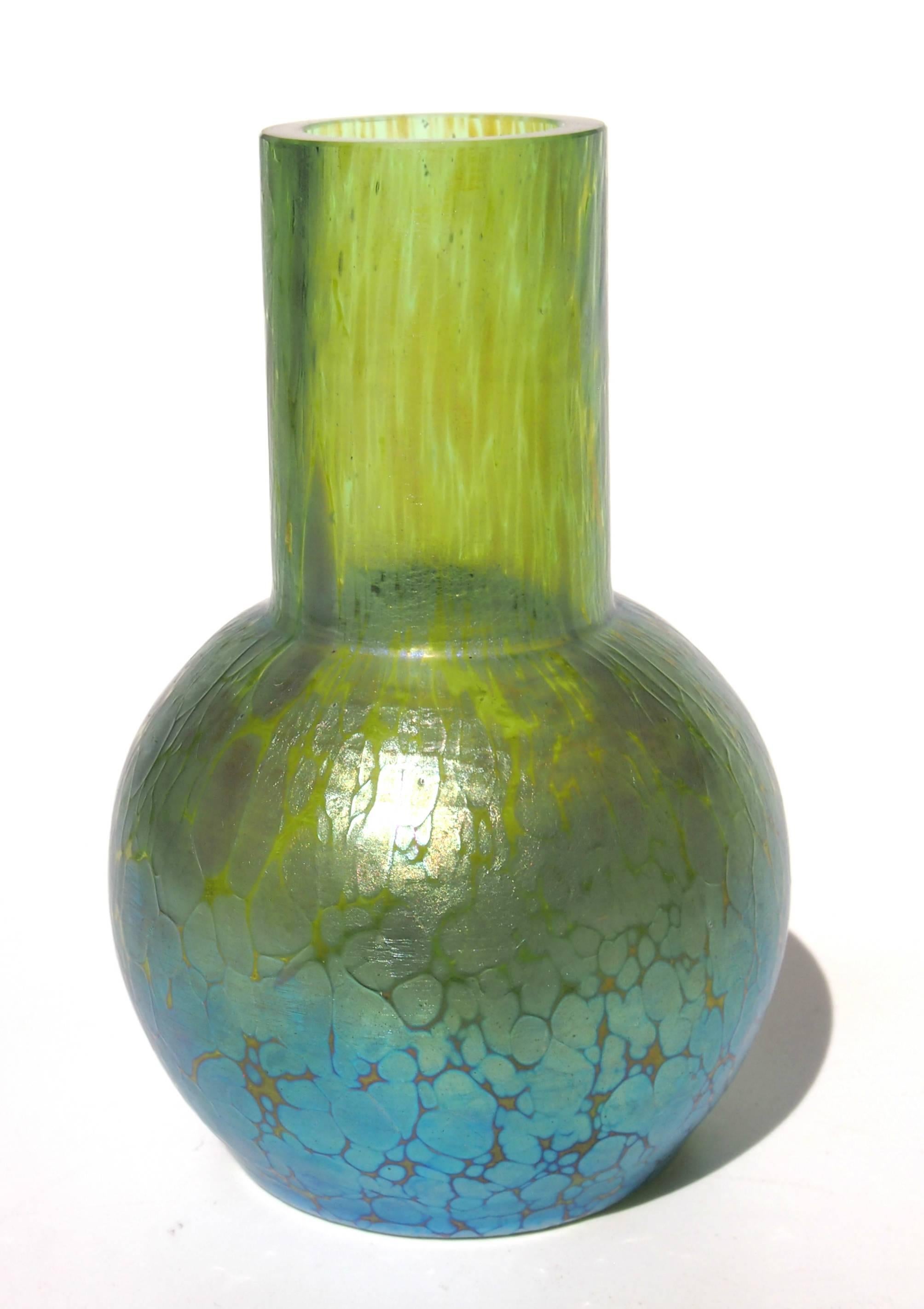 Super Loetz Crete (green glass) Papillon (butterfly wing) small vase in the Classic globe and shaft shape -the iridized finish is particularly pleasing- It has a cold cut top and no pontil mark.