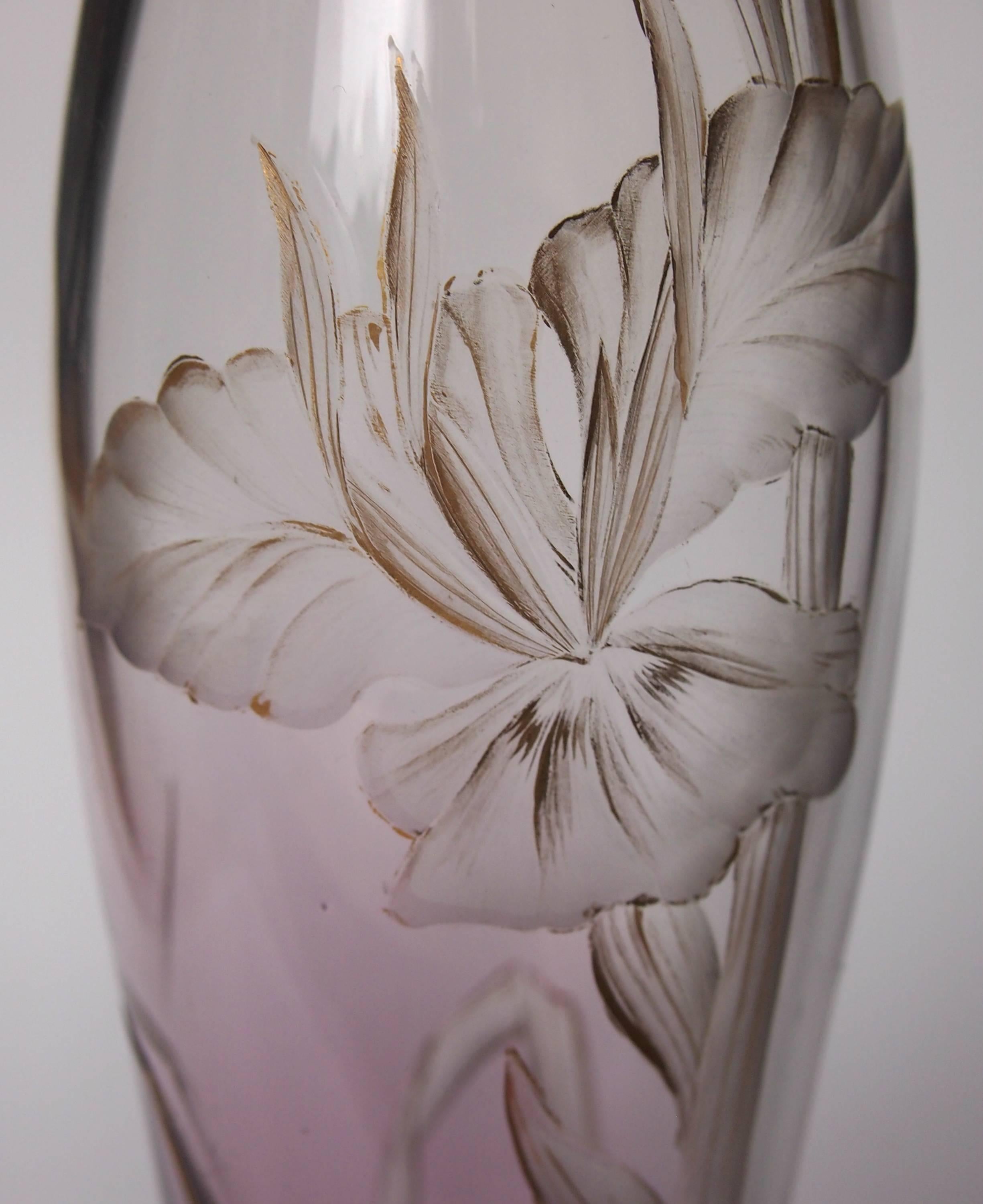 A very striking Art Nouveau Harrach vase clear going down to purple, finely intaglio cut with lilies. The vase is gilded and decorated to the base with a Vienna Secession like star pattern. Only in the most superior Harrach intaglio cut pieces was