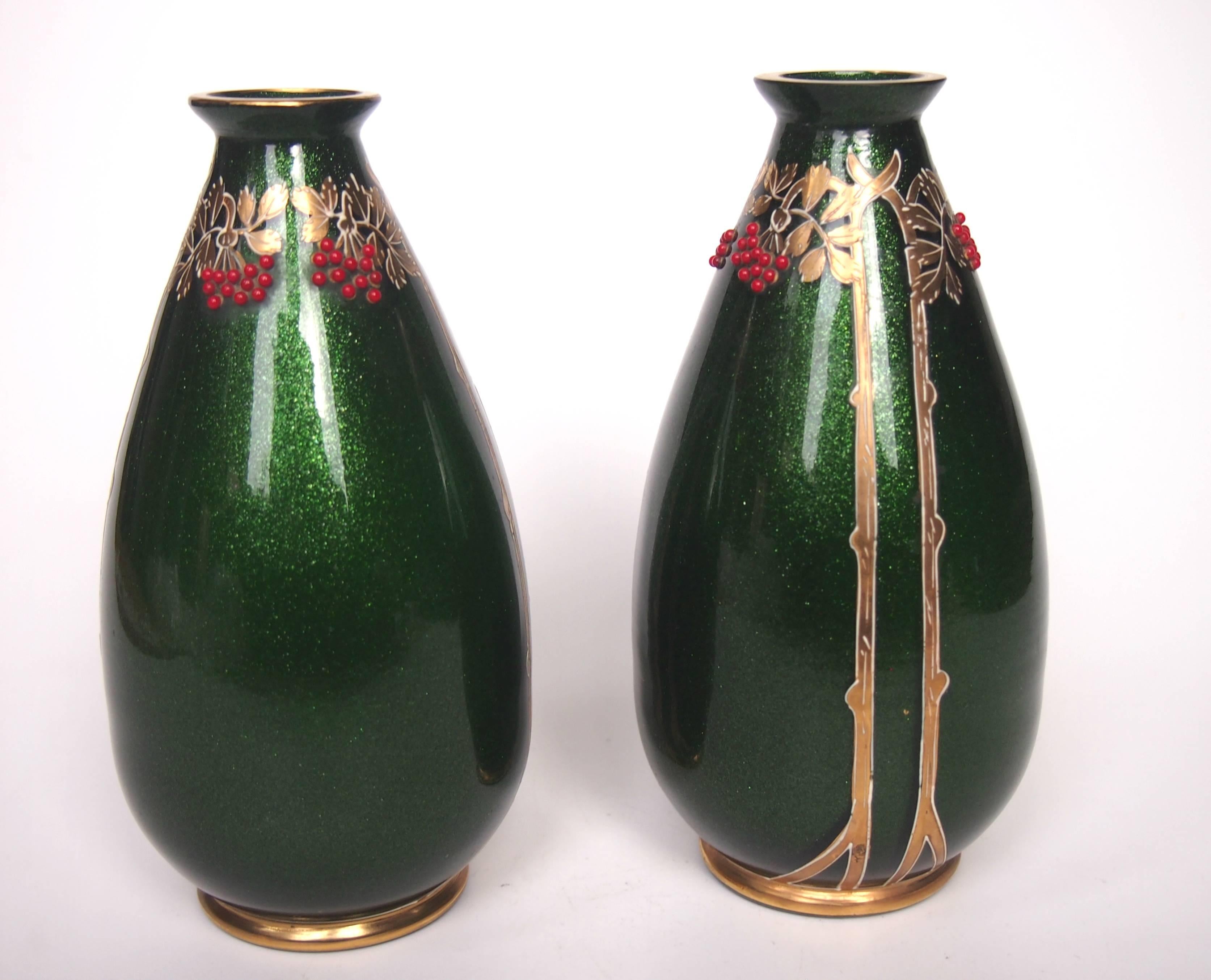 A super pair of Riedel vases in green aventurine (a sparkly green) with gilding over white enamel and tiny applied red glass beads. Riedel used a combination of the European styles of the time merging elements of Art Nouveau, Jugendstil and Vienna