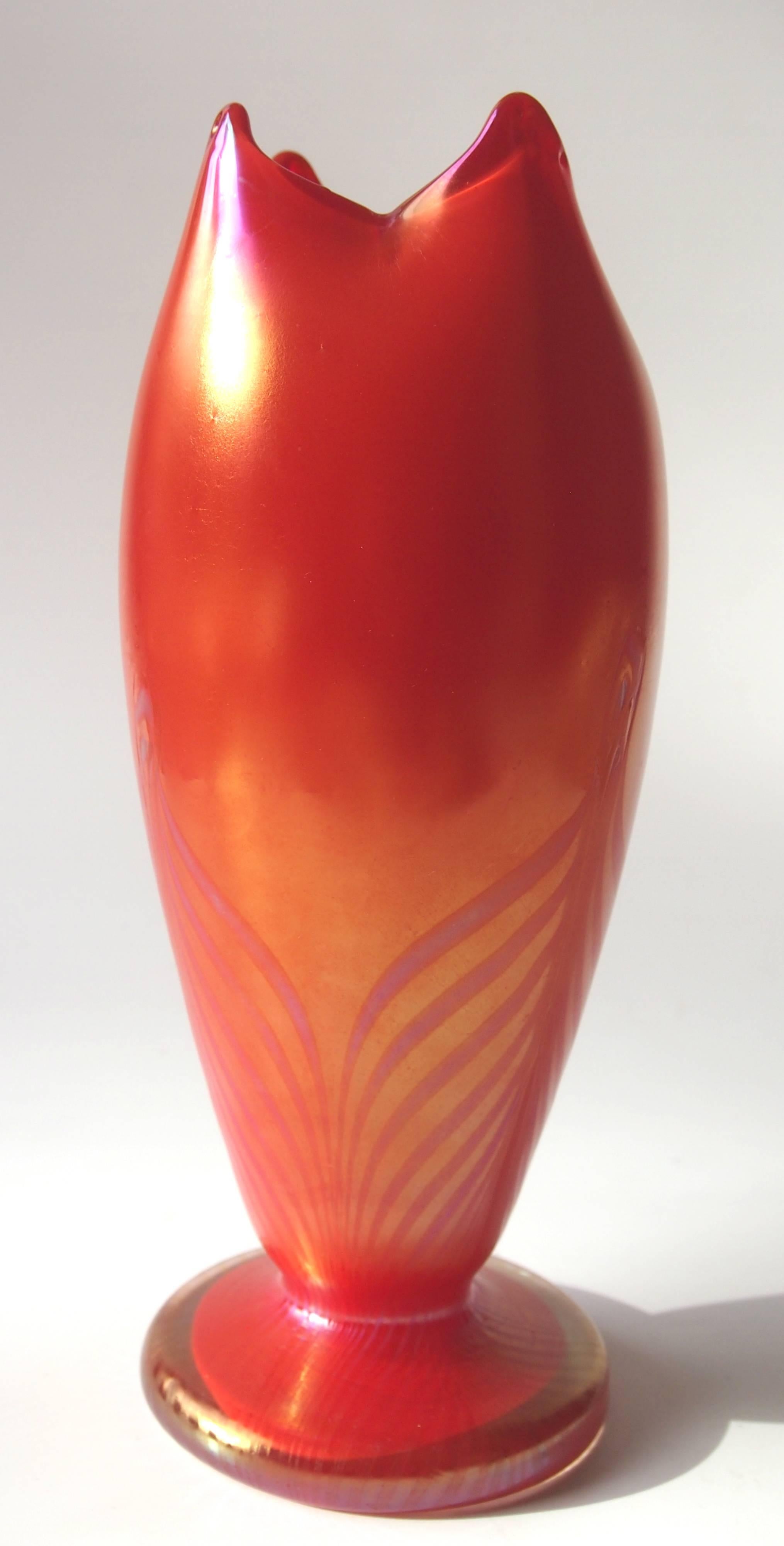 Stunning and very rare red pulled and feathered vase. The vase has vibrant color and subtle feathering superbly executed with four hot pulled points. There is a similar example in the Kralik room at the great glass museum in Passau.

Kralik was at