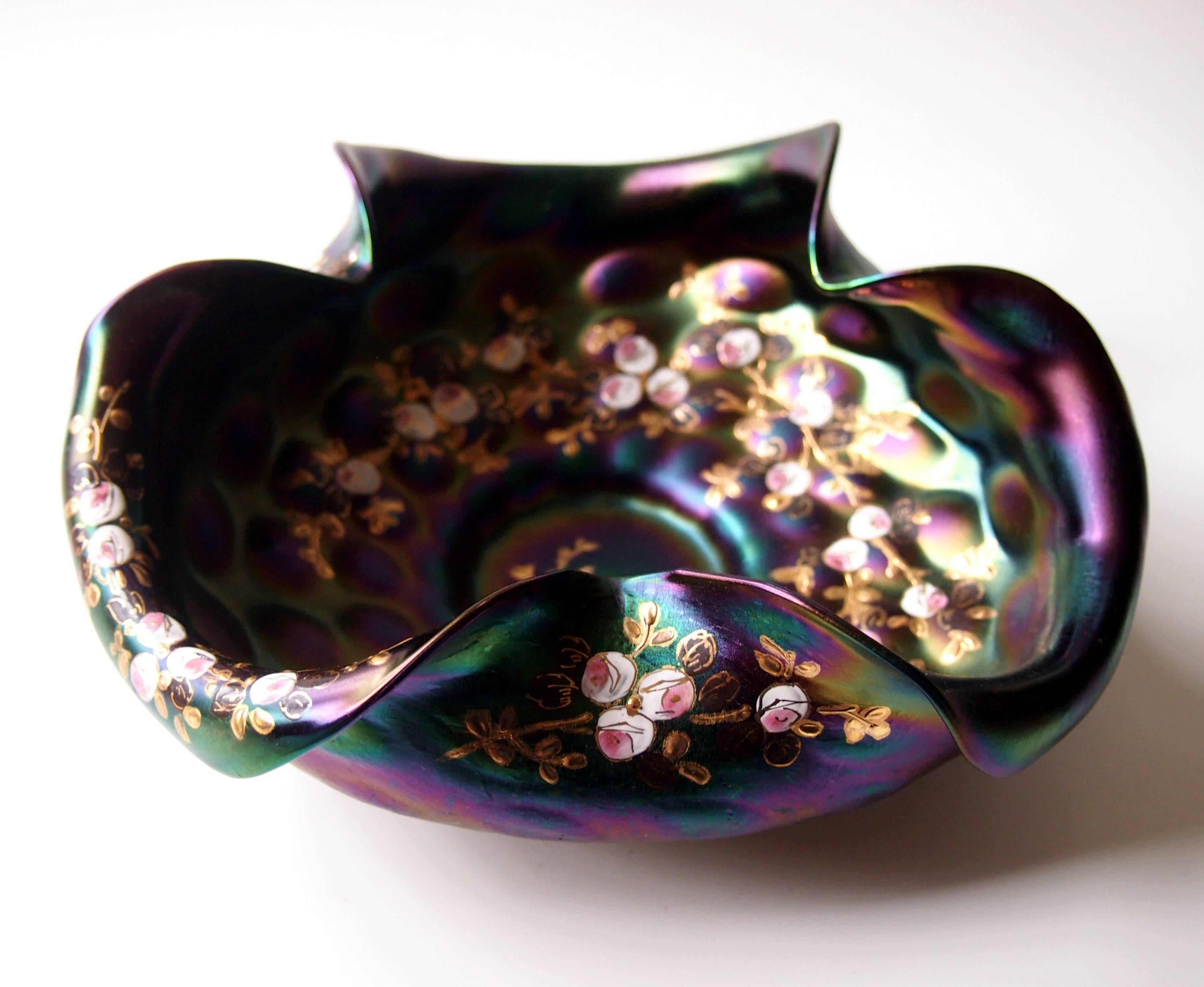 Fine Rindskopf enameled, hand tooled and shaped Jugendstil open bowl - in a near opaque black iridised color -highlighted with reds, greens, blues and pinks -enameled and gilded on the edges and interior with flowers.

Rindskopf was one of the