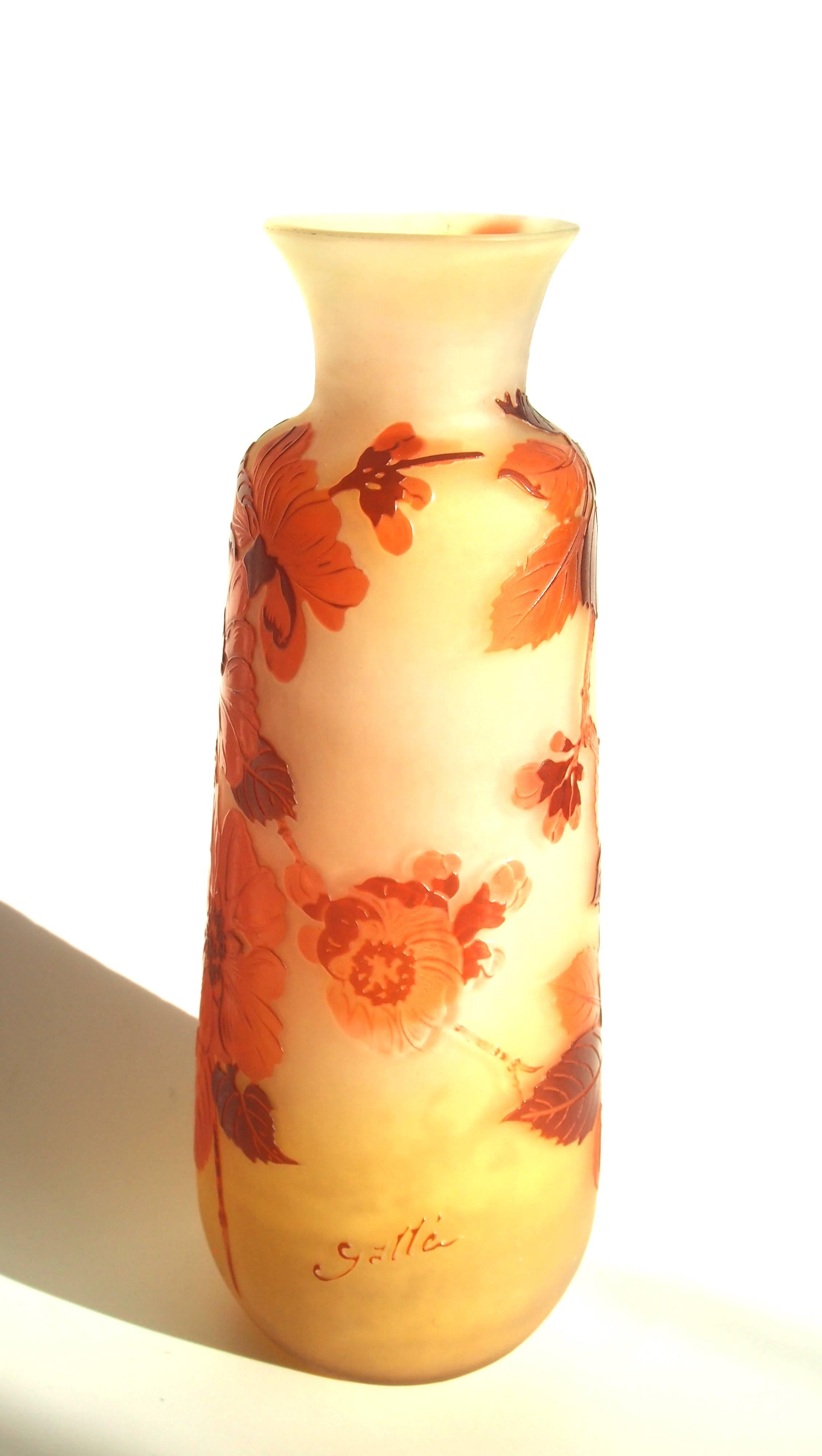 Unusual Emile Galle cameo vase in dark red, and bright red over orange depicting Apple blossom falling from above (most Emile Galle images are from the bottom up only a few of his finest vases have the image coming down from above), circa 1900,