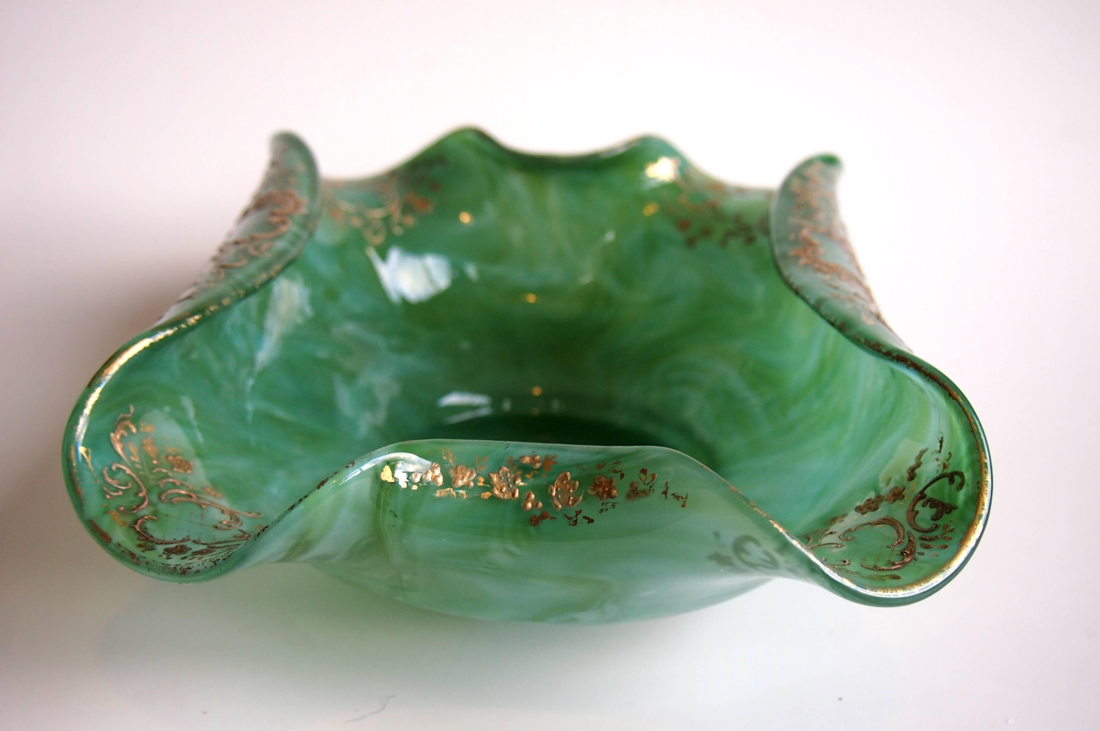 Super Loetz gilded and turned in open bowl in the Malachit finish. One of the marbled series of patterns Malachit is designed to look like Malachite stone with streaks of light and dark green. It's decorated in raised gold with one of Loetz's most