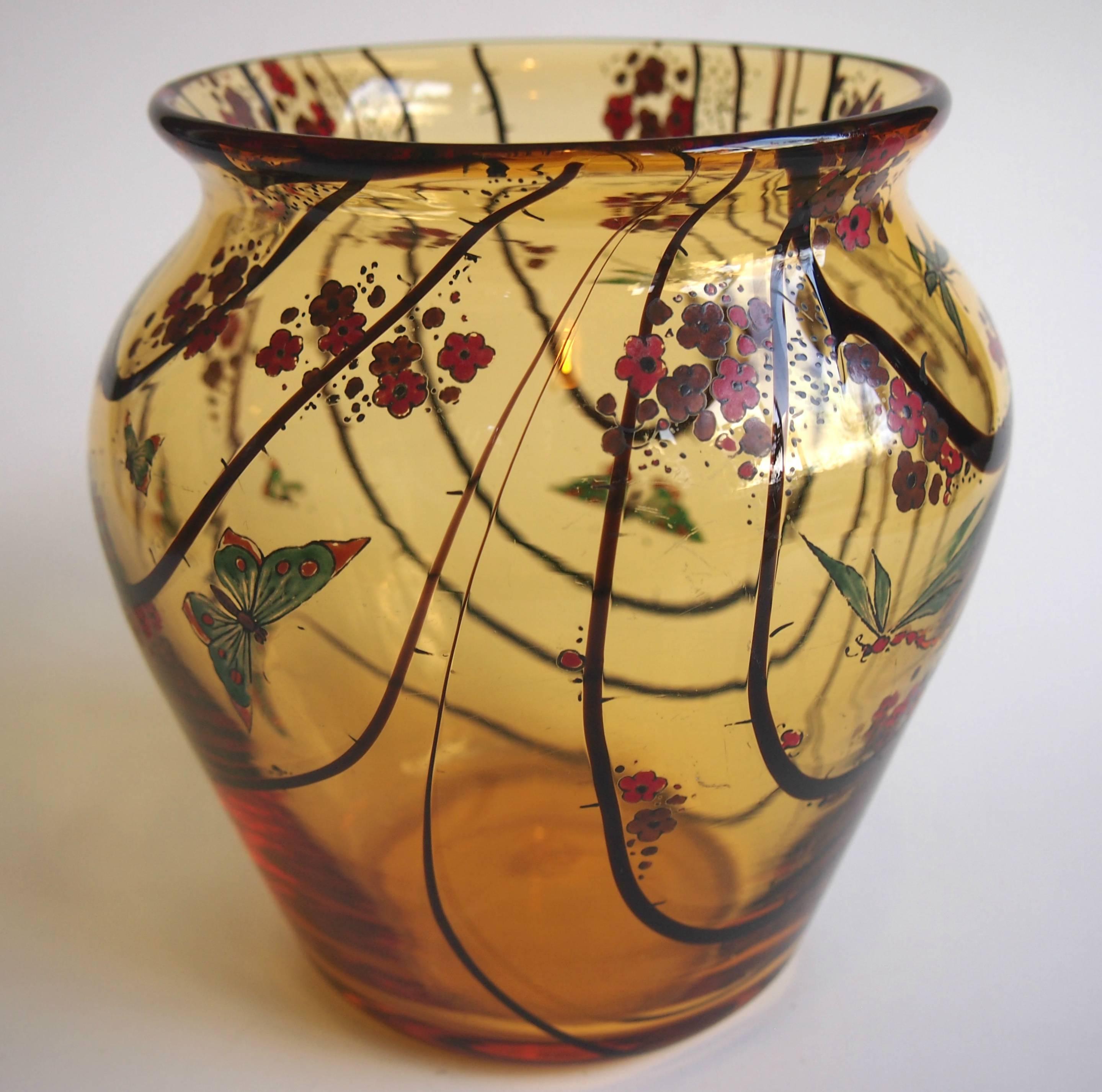 A stunning amber with random brown frond vase decorated with polychrome enamelling featuring blossoms and a variety of insects; Butterflies, Dragonflies and Moths. Stuart Crystal briefly made a series on enamelled pieces in the Art Deco style from