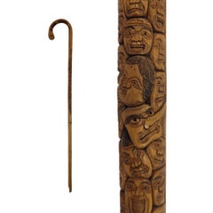 Canne japonaise de l'époque Meiji, en bois sculpté, ornée de multiples visages et de bambou