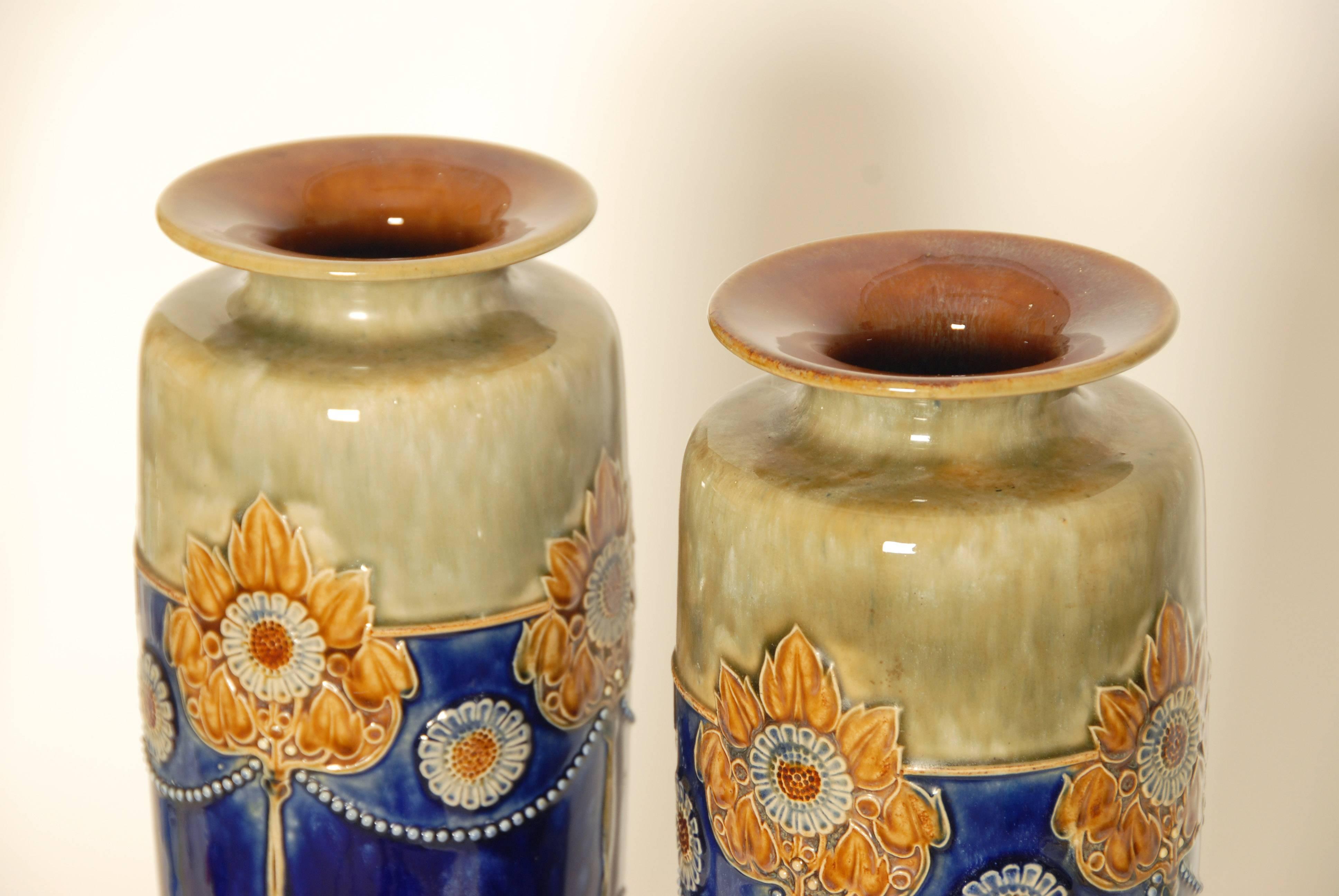 A pair of large and impressive Art Nouveau Royal Doulton stoneware vases.
Hand-painted with stylized flowers, factory marks and numbered 6621 on the bases.
Measure: 14.5 inches high.

 