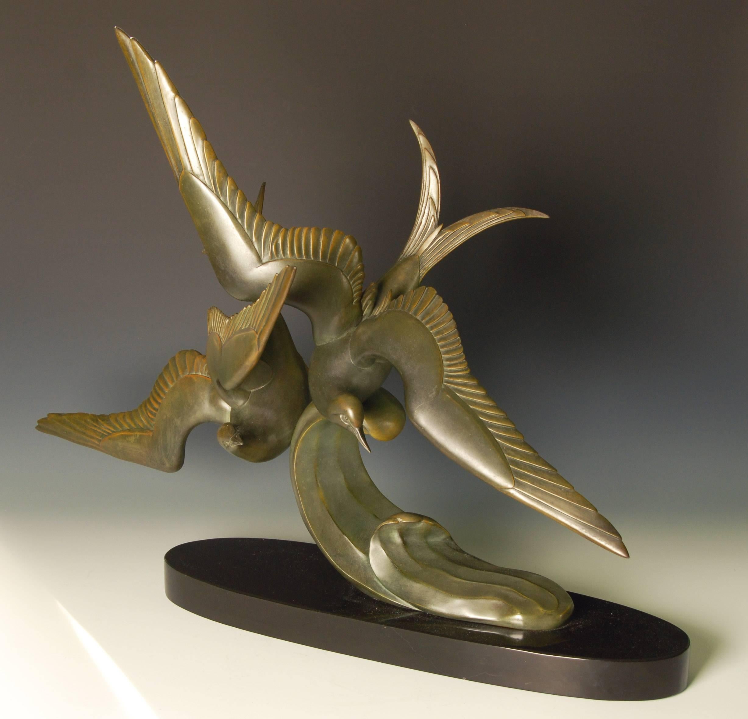 Art Deco bronze sculpture of terns in flight over a wave, by Irenee Rochard (1906-1984) on a polished black marble base.
This is a bronze piece (not spelter) and is extremely heavy and substantial weighing around 50 ibs or 23 kg.