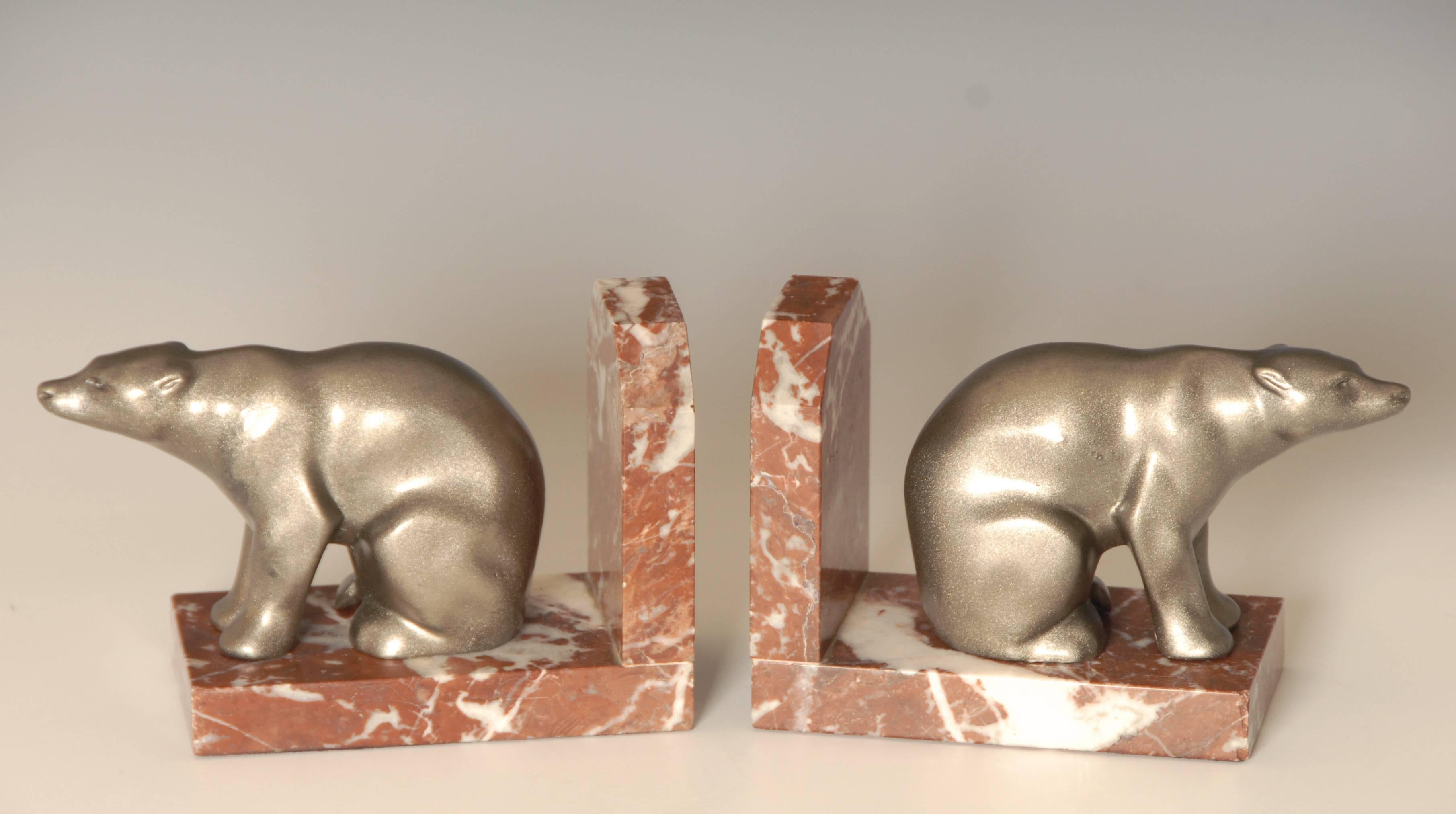 A charming pair of Art Deco white metal on marble bookends from circa 1930.
Each one measures 6.5 inches long x 4.25 inches high.

Price includes shipping to anywhere in the world.

 