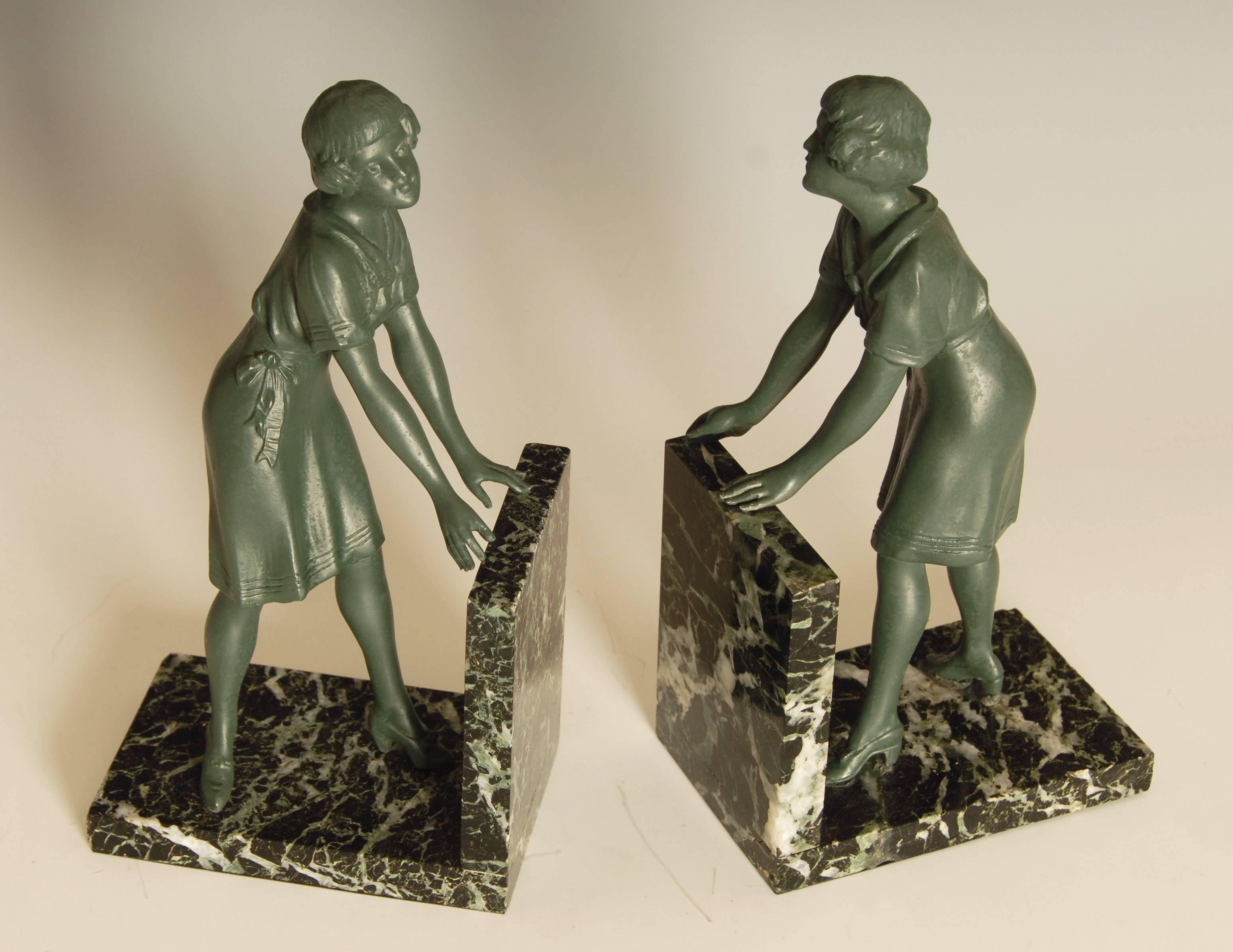 Unusual and charming pair of French Art Deco green patinated metal on green marble base bookends.
Modelled as two young ladies in conversation.

Price includes shipping to anywhere in the world.