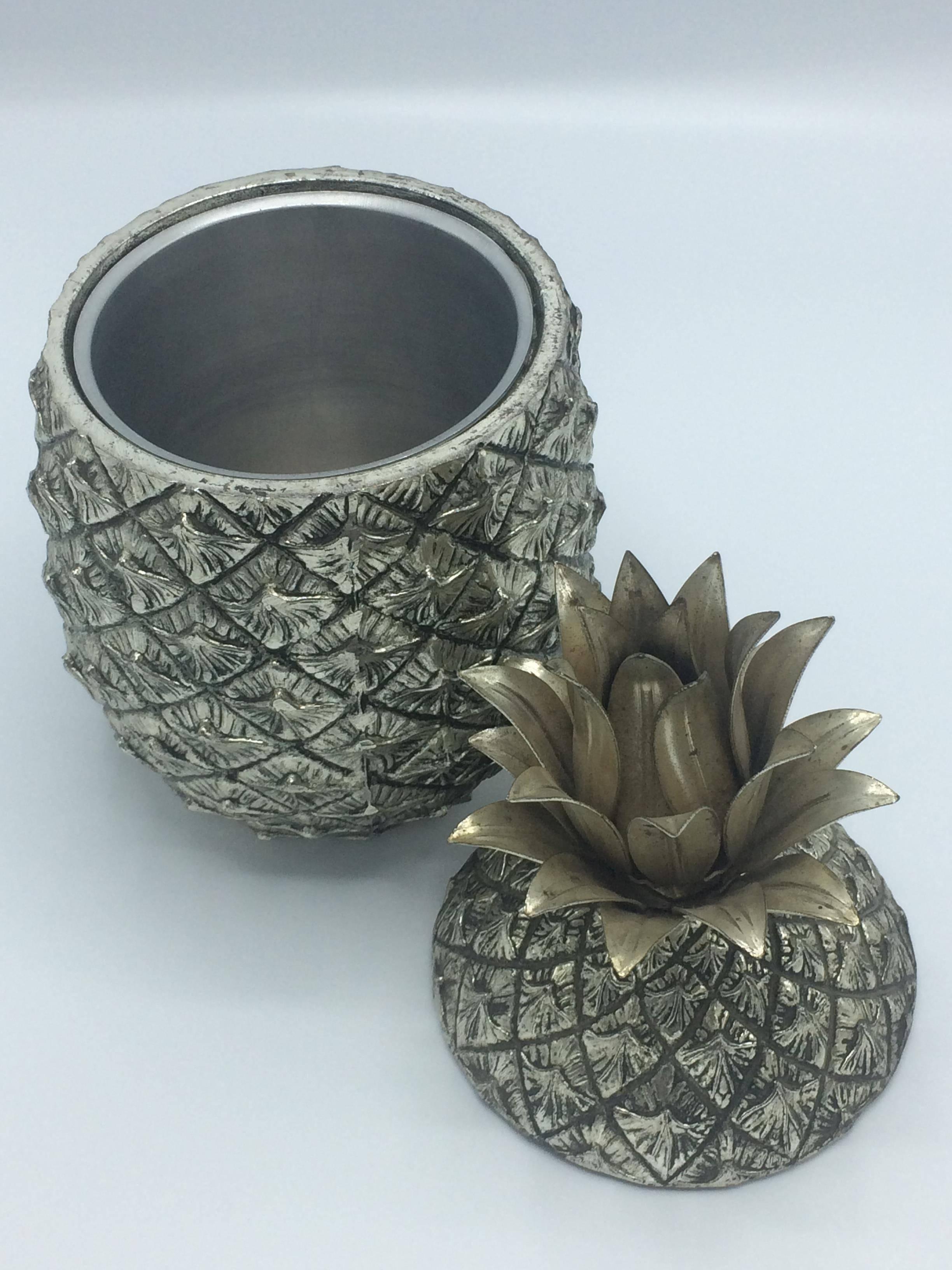 This pineapple shaped ice bucket is from the 1960s and designed by Mauro Manetti, it’s a gorgeous authentic piece of barware. Signed on the bottom. Made in Firenze, Italy. As shown in the photos the crown of this ice bucket has lost some of its