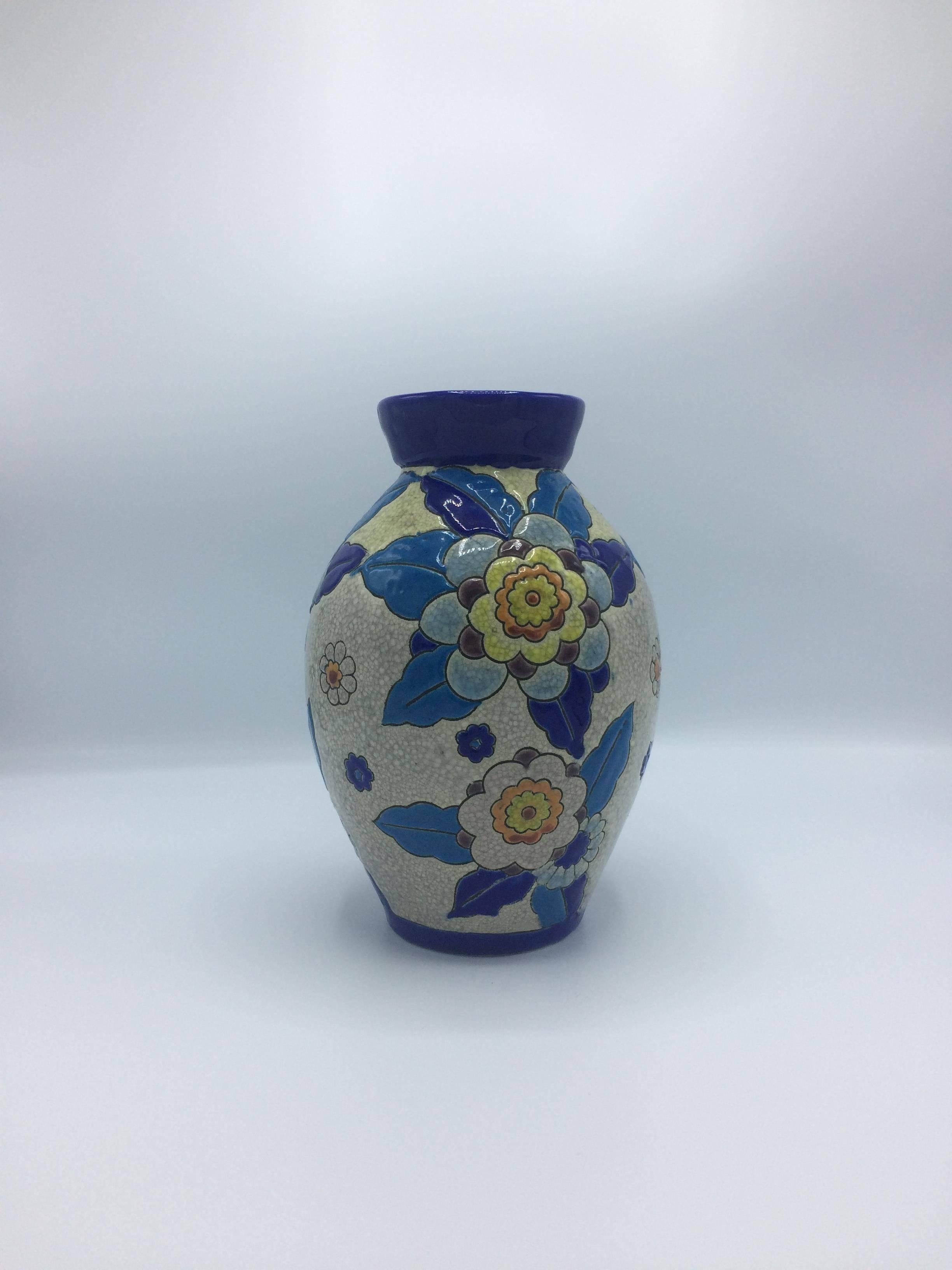 This impressive vase was made in Belgium by Keramis, which later made Boch Freres ceramic. This is an early example of the style often used in Bochs floral decals. This vase is in true excellent condition, colorful craquelé, no chips, no cracks.