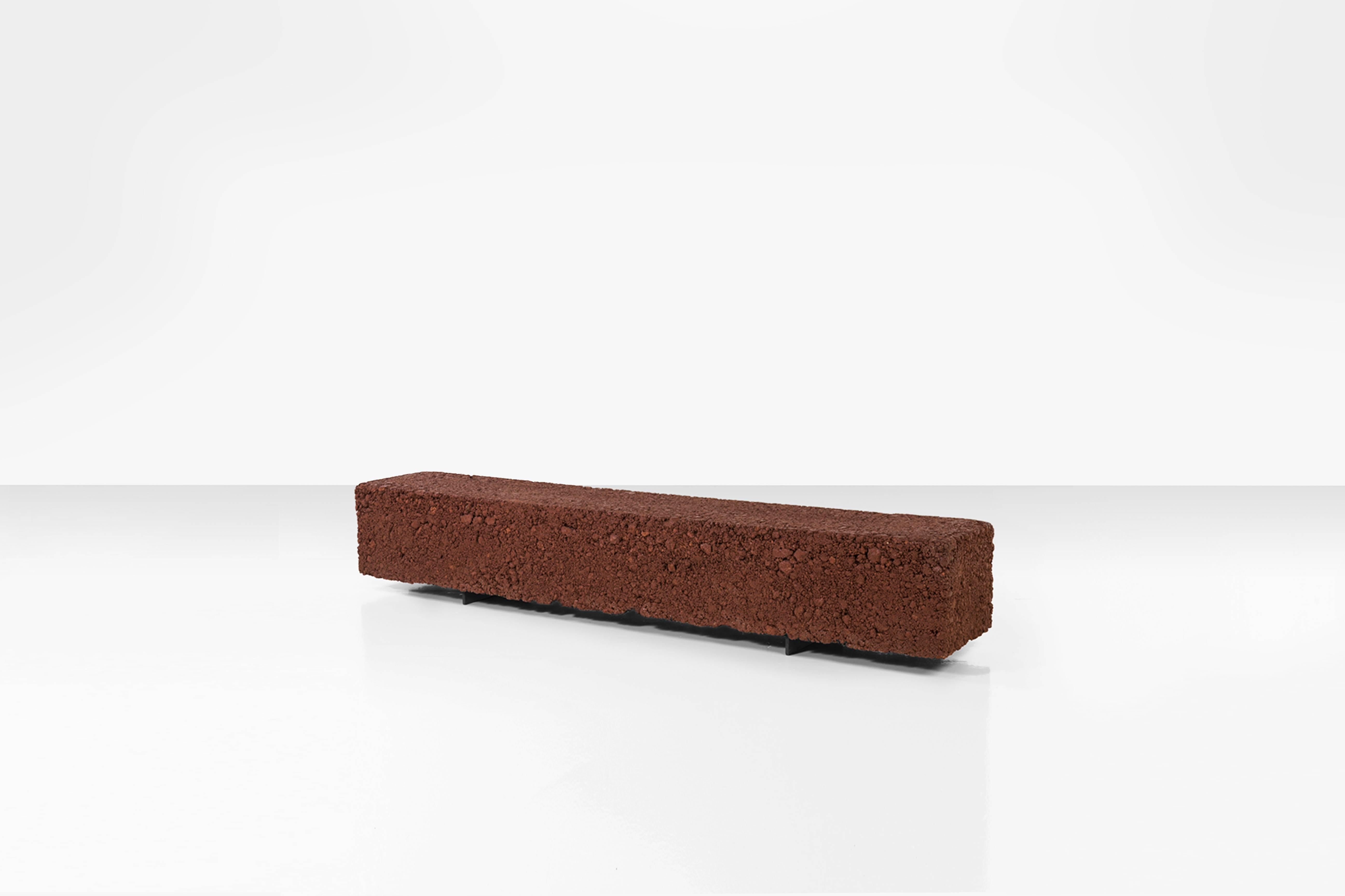 Organic looking cuboid shaped bench, designed by artist, designer Domingos Tótora. Made of recycled and painted cardboard, it rests on two simple iron supports, giving it a clean but natural character.

About the artist:
Domingos Tótora (born and