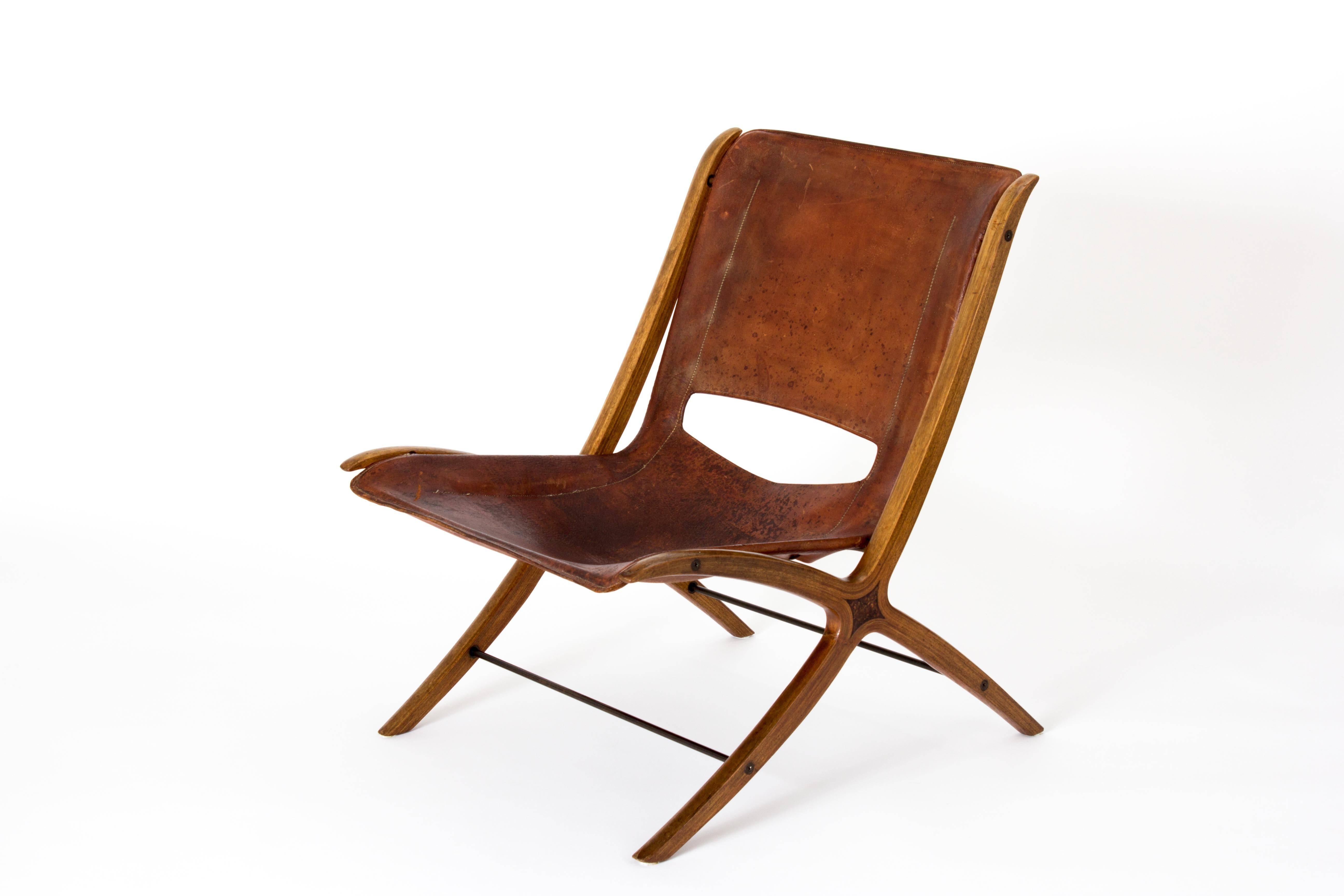 Rare easy chair or X-chair designed by Peter Hvidt & Orla Mølgaard-Nielsen in leather, mahogany. Produced by Fritz Hansen in Denmark, 1950s-1960s.

This chair has aged as beautifully as Helen Mirren. It's battered and scarred but the aging and