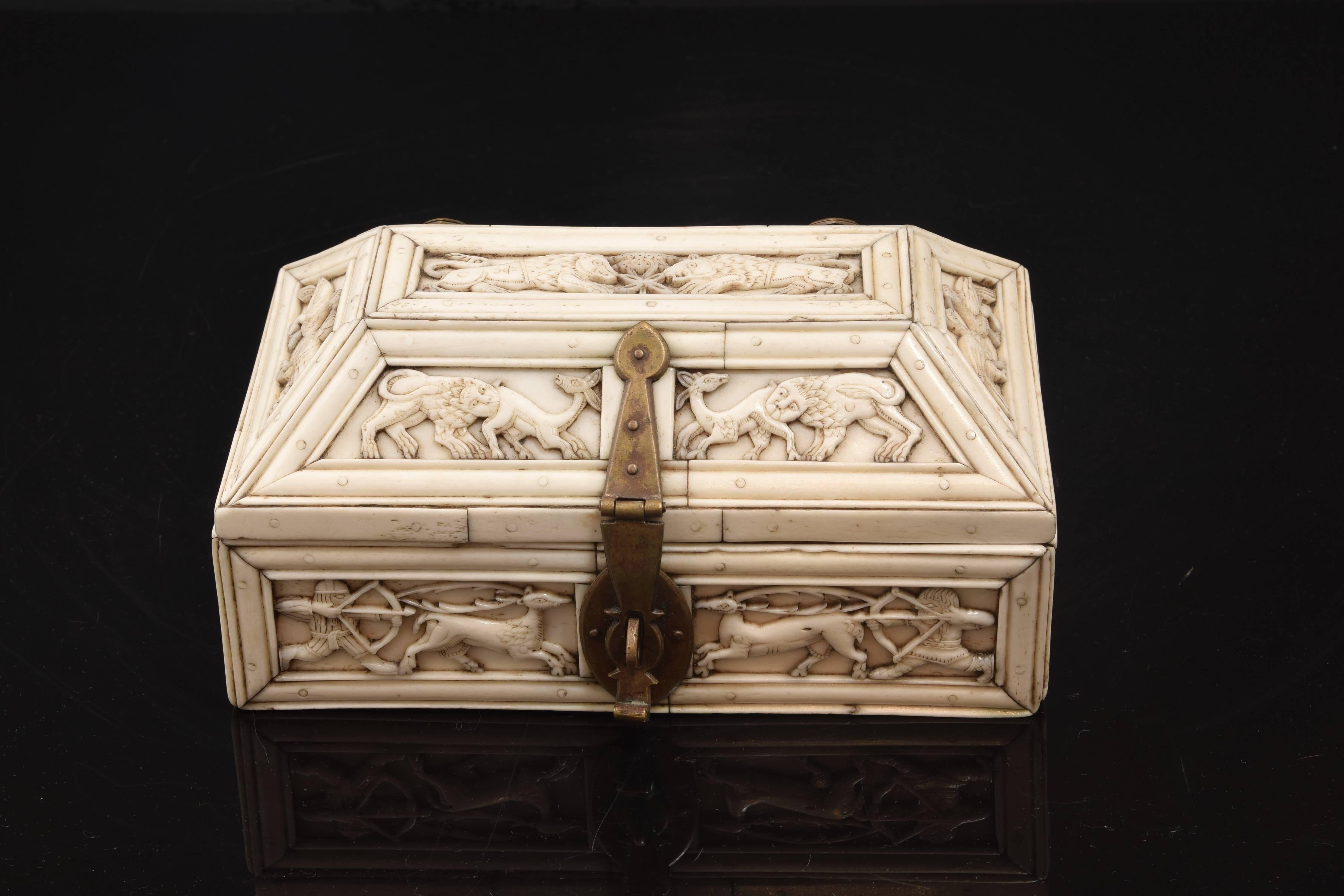 Neo-Romanesque chest. Carved bone. 20th century.
Carved bone casket with rectangular base and lid in the shape of a trough, which has a series of metal fittings on the outside. Both the type of the piece, as the form, the decoration (animals