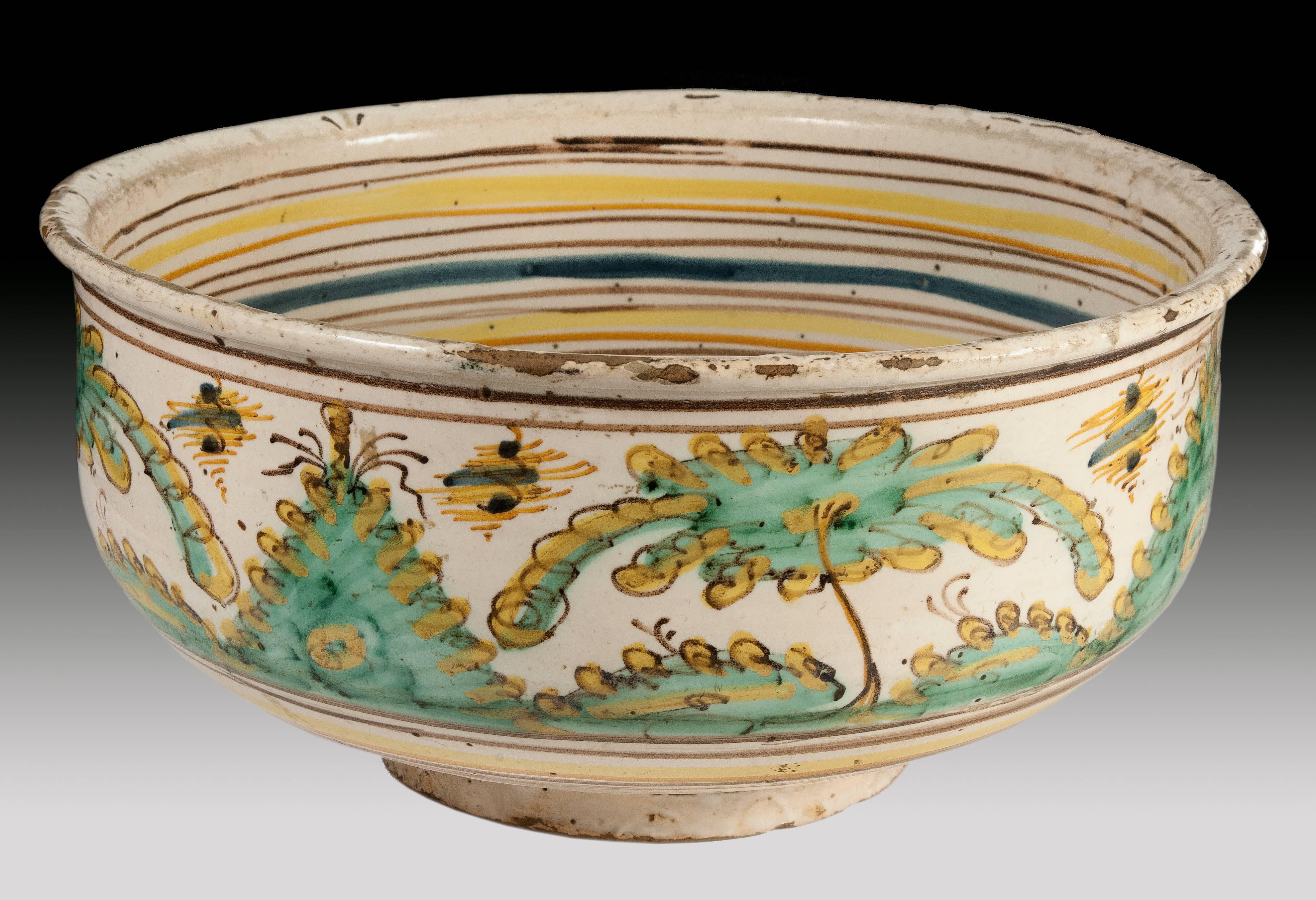 Ceramic bowl decorated with high-temperature enamels on a white opaque tin slip. The polychrome is based on colors typical of Talavera: cobalt blue, copper green, manganese black, antimony yellow and ocher, browns and iron oranges. These glazes were
