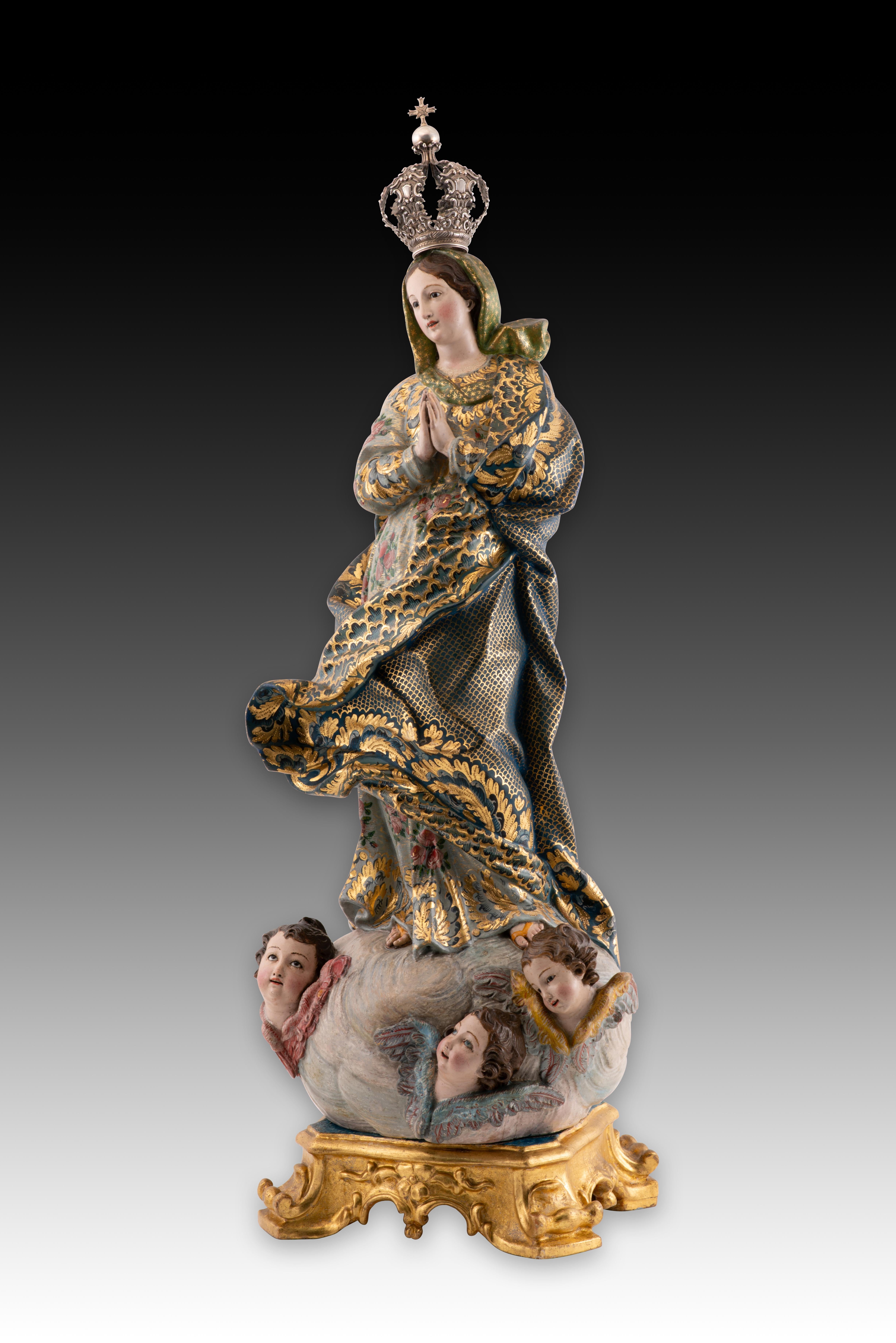 Immaculée Conception. Bois sculpté et polychrome, verre, argent. École portugaise, 18e siècle. 
Sculpture en bois représentant une jeune Marie, les mains jointes devant la poitrine dans une attitude de prière, debout sur un nuage d'où émergent des