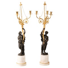 Pair of candlesticks. Marble, gilt and patinated bronze. AFter Clodion, 19th c.