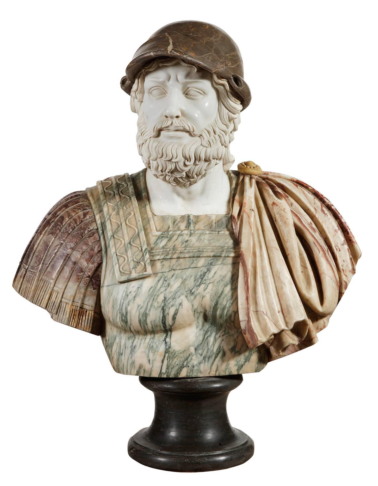 Bust of Classic style, following models of the Roman portrait, representing a bearded man, of serene expression, dressed in armor and mantel and covered by a helmet. The carnations are carved in white marble, with a polished finish on the skin and