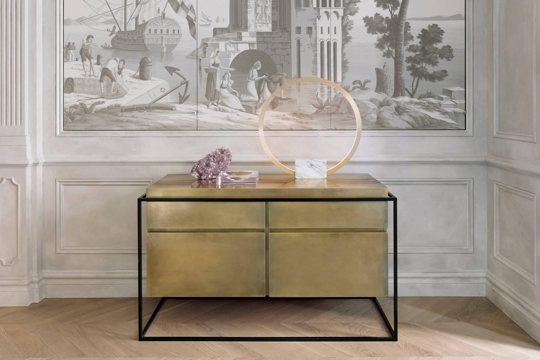 The Hyperion sideboard is a brass-clad carcase suspended within a steel frame. A black stained timber veneer finishes the interior. 
The piece is fitted with two shallow drawers to the top and two deep drawers to the bottom. 
The Hyperion can be