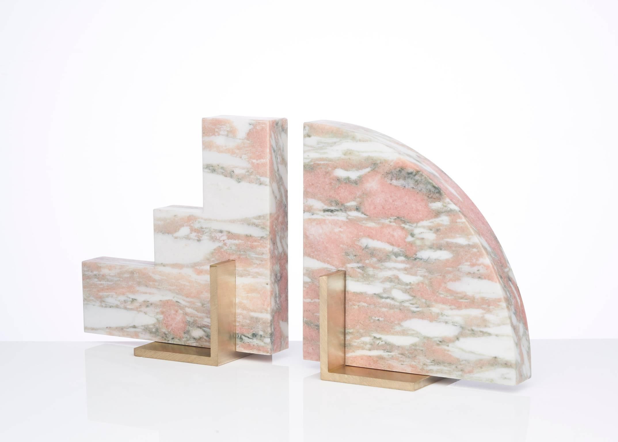 Meet Curvy and Steppy; the two individual bookends which as a pair are known as The Odd Couple Bookends.
Here shown in a honed Norwegian Rose marble with a brushed brass base.
The marble is cut into two geometric shapes and balanced over a brass