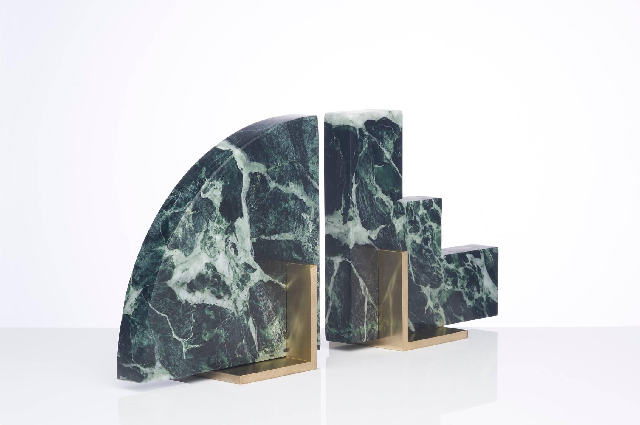 Meet Curvy and Steppy; the two individual bookends which as a pair are known as The Odd Couple Bookends.
Here shown in a honed green marble and a brushed brass base.
The marble is cut into two geometric shapes and balanced over a brass angle.
The