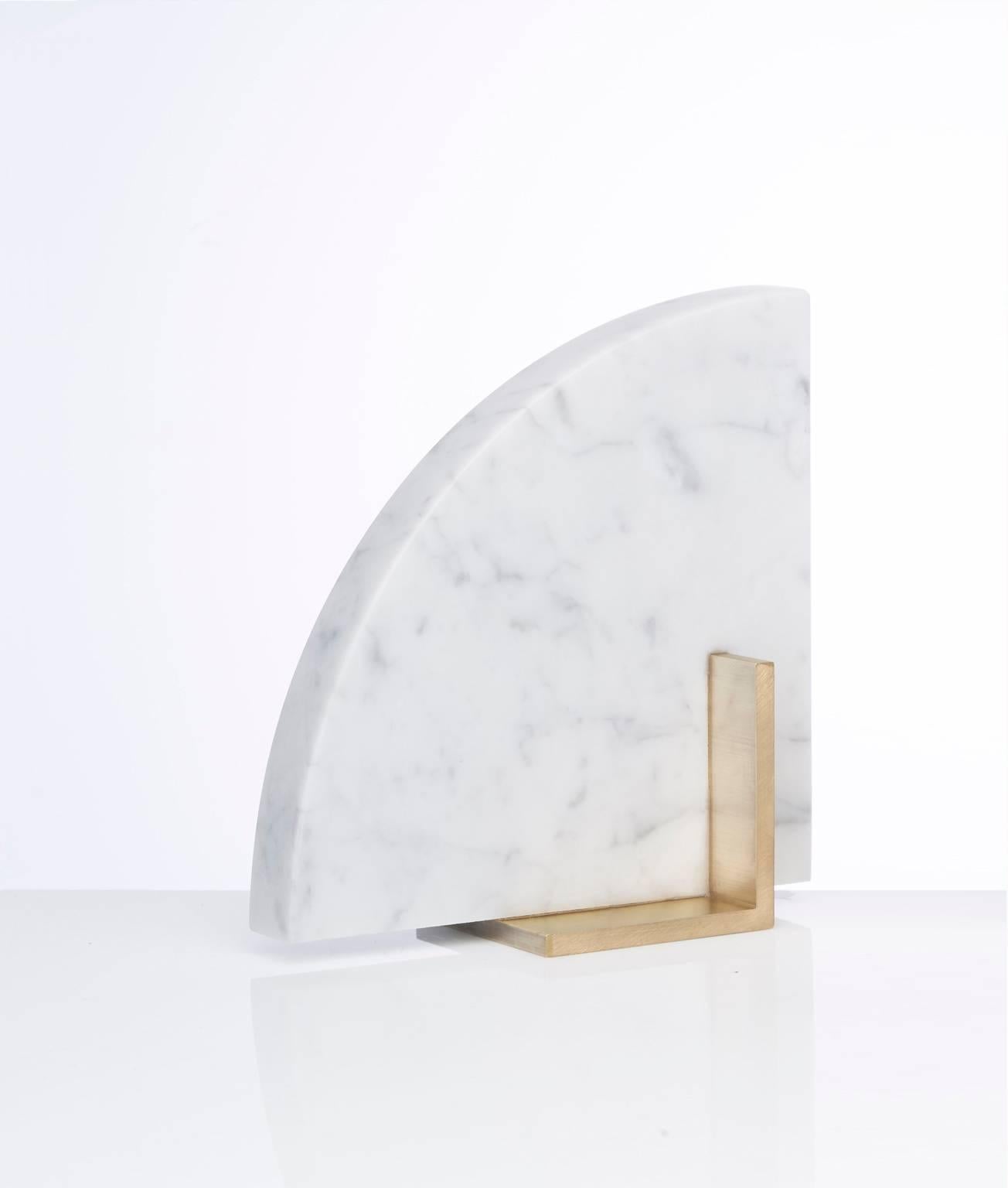 Meet Curvy; one half of the odd couple bookends set which are now available to buy individually. You can now mix and match colors and shapes.
Curvy is available in Carrara marble and a brushed brass base.
The marble is cut into a geometric shape,