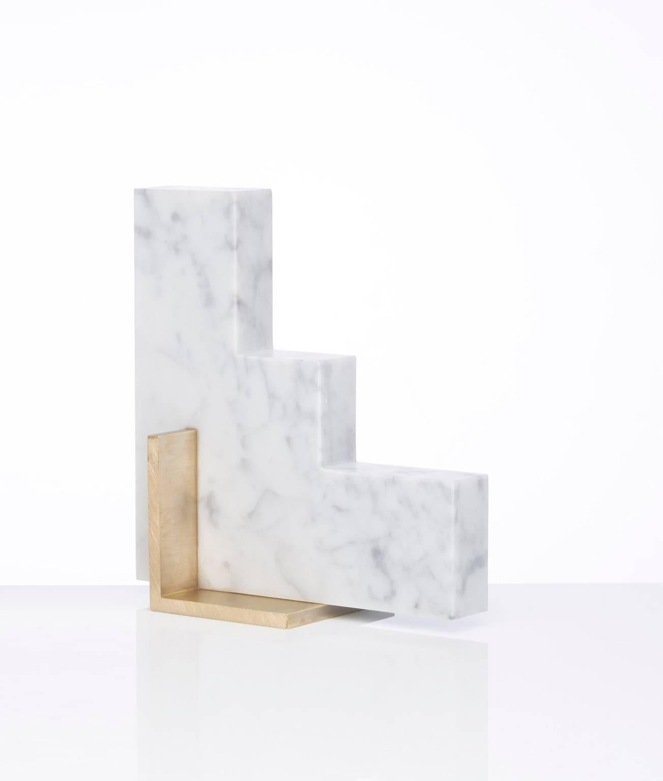 Meet Steppy; one half of the odd couple bookends set which are now available to buy individually. You can now mix and match colors and shapes.
Steppy is shown here in Carrara marble and a brushed brass base.
The marble is cut into a geometric