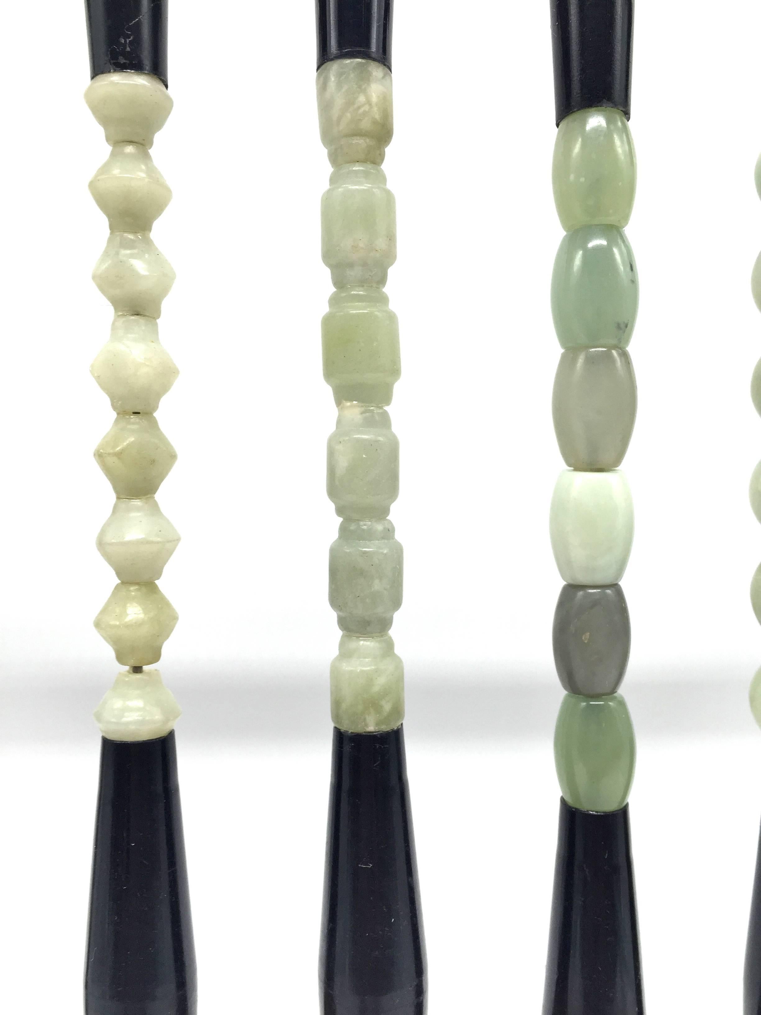Beautiful collection of calligraphy brushes, each adorned with hand carved jade beads. These brushes make stunning displays, can be used to paint watercolor or make Chinese ink calligraphy. Natural horse hair. Come with our beautiful 6-peg wenge