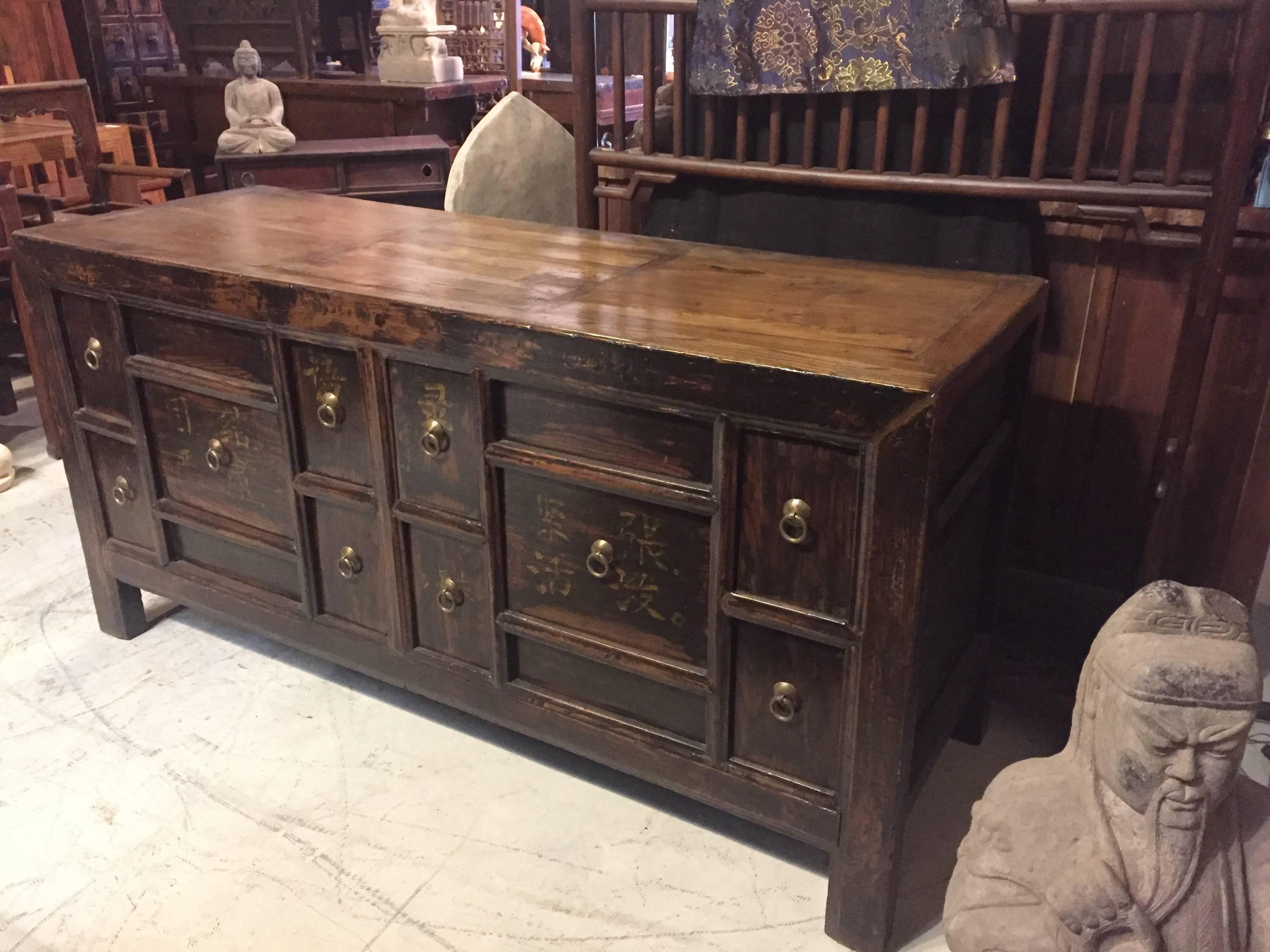 This is a heavy, substantial chest made with thick wood. The framework and top are solid and strong. There are 10 drawers with remnants of old writings on the front. They say 