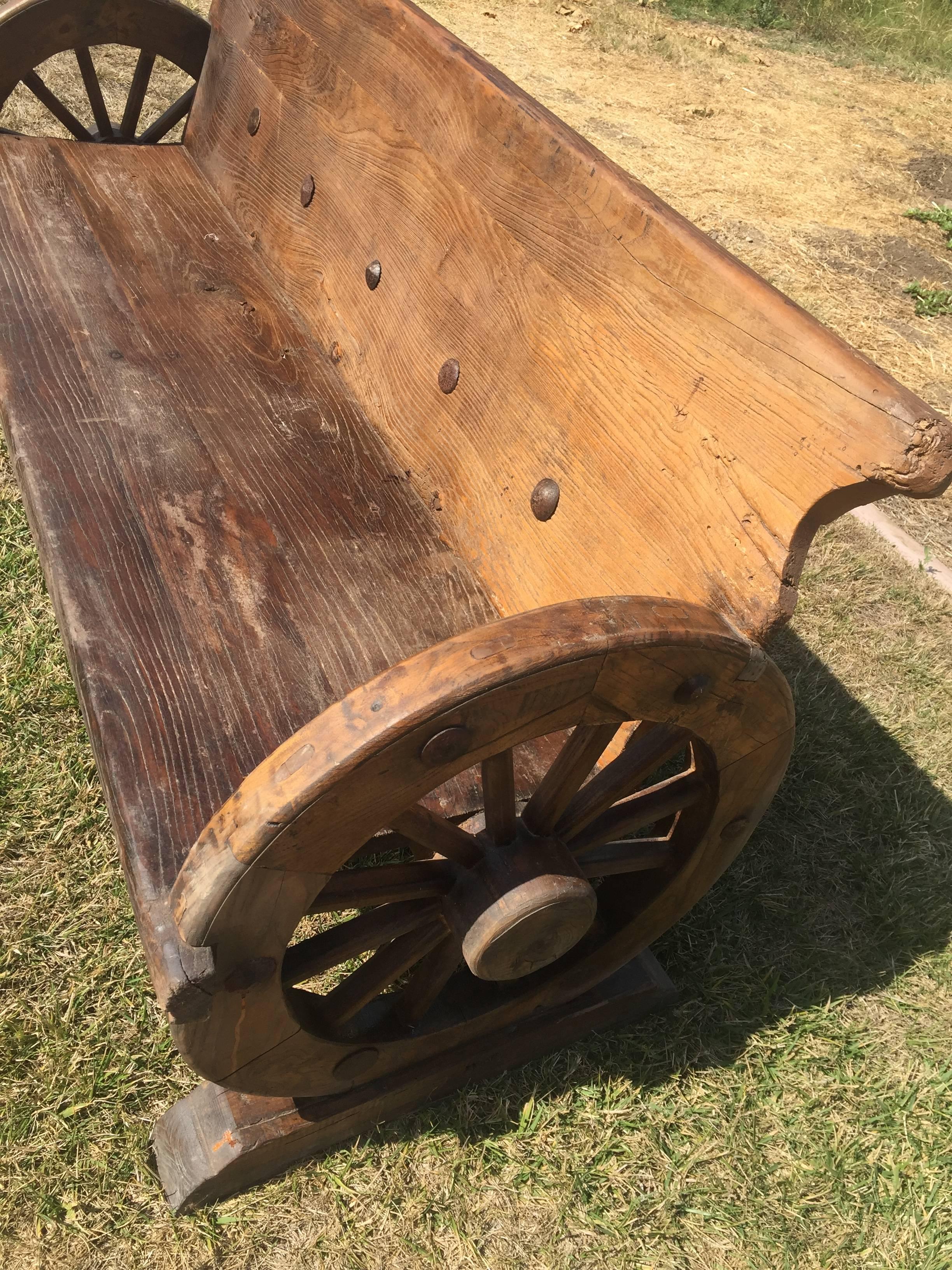 Joinery Rustic Bench with Antique Wheels and Iron Studs