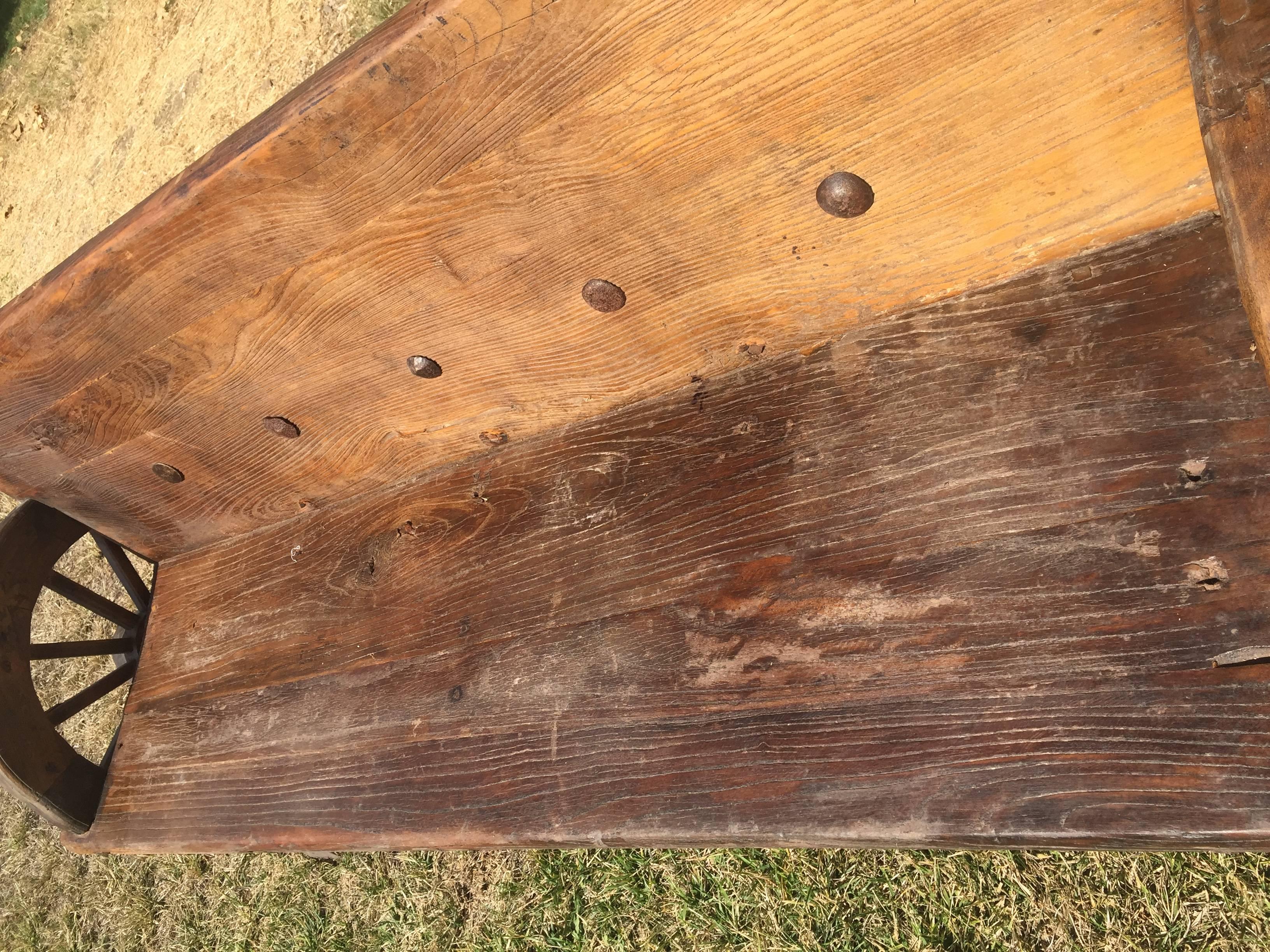 Rustic Bench with Antique Wheels and Iron Studs In Good Condition In Somis, CA