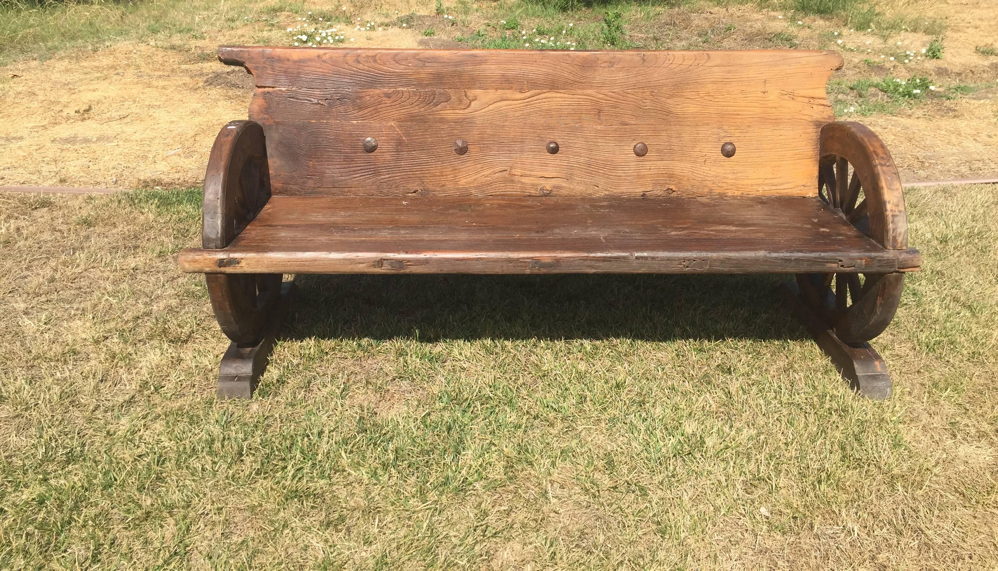 Chinese Rustic Bench with Antique Wheels and Iron Studs