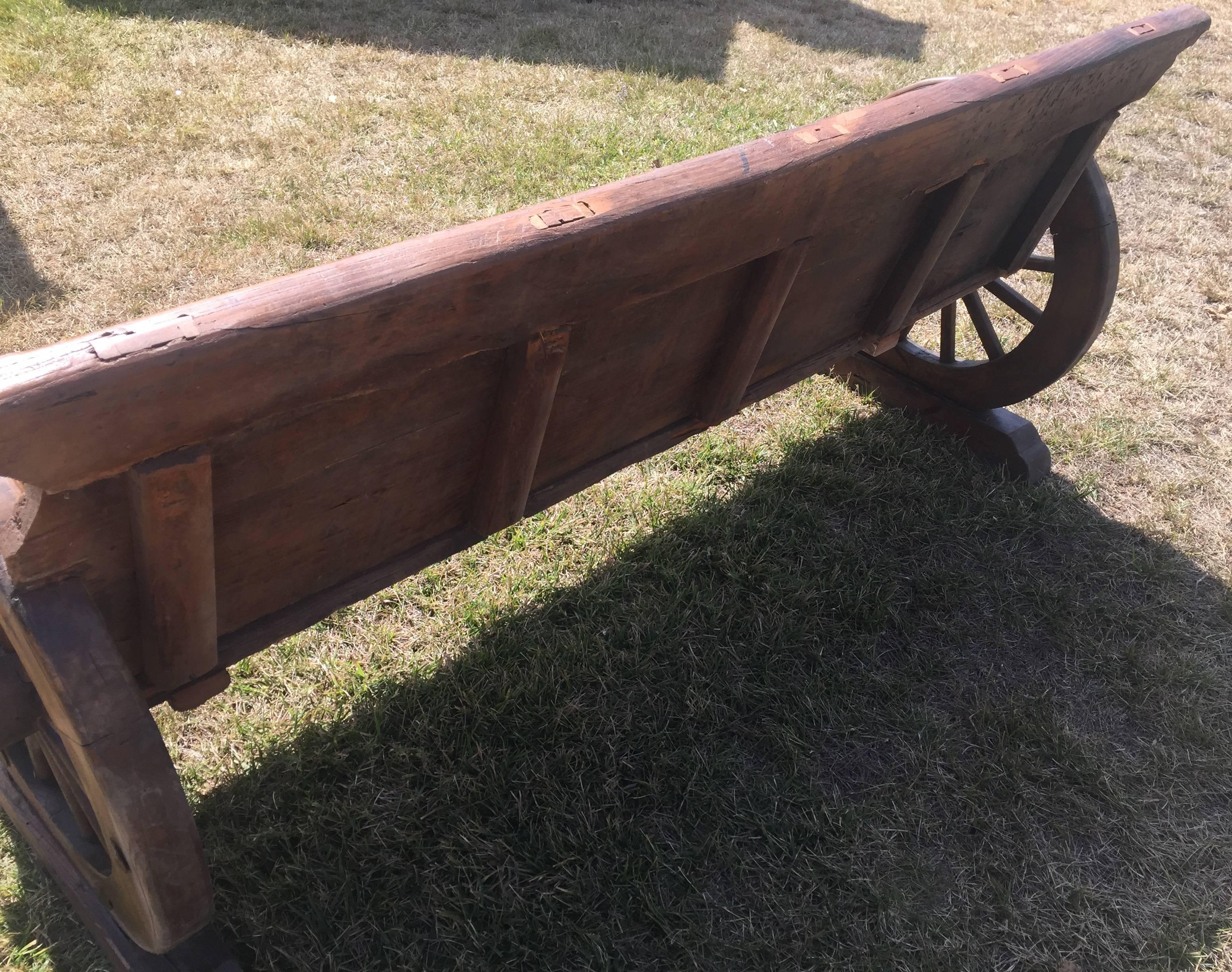 Rustic Bench with Antique Wheels and Iron Studs 2
