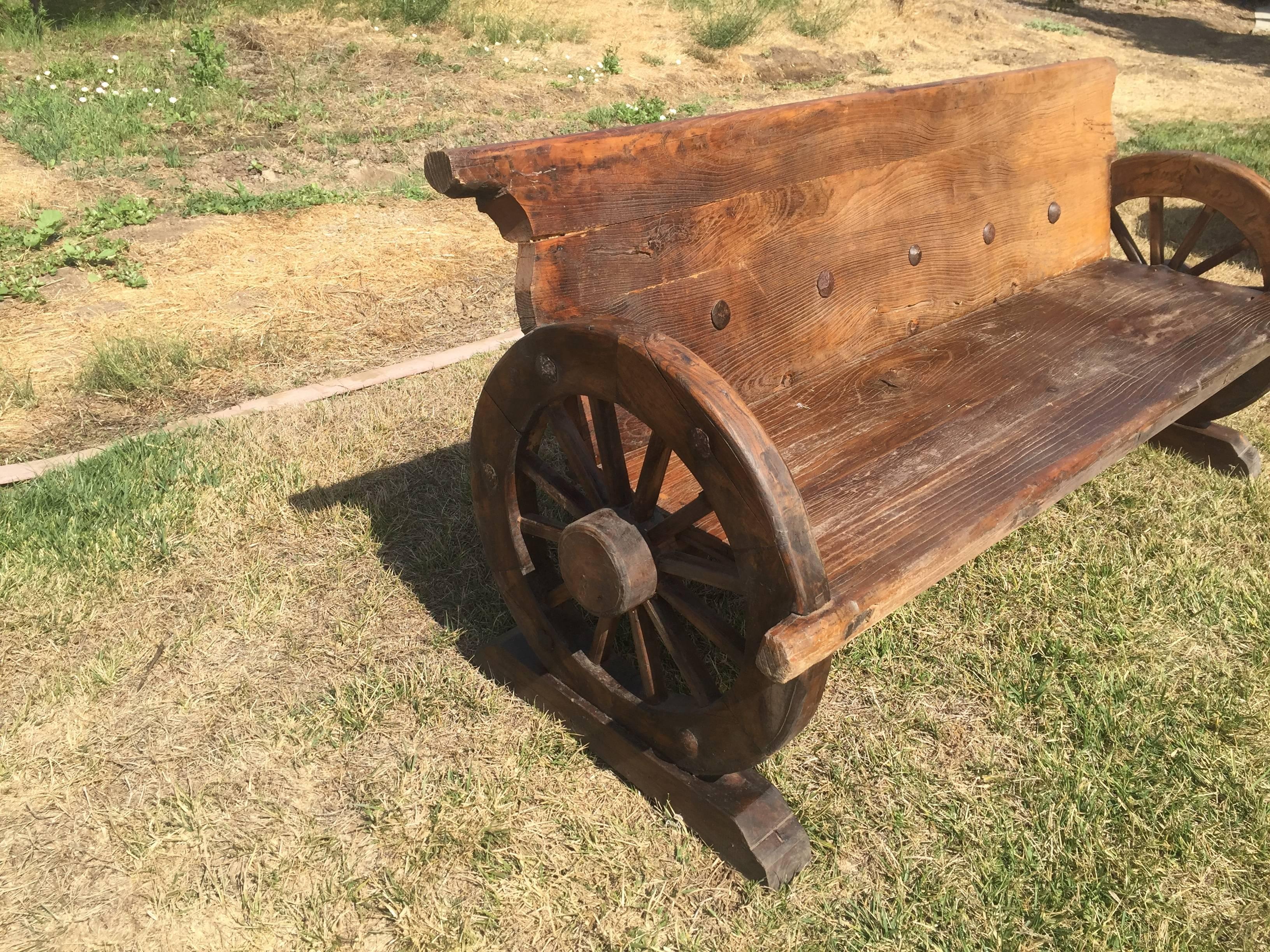 Rustic Bench with Antique Wheels and Iron Studs 1