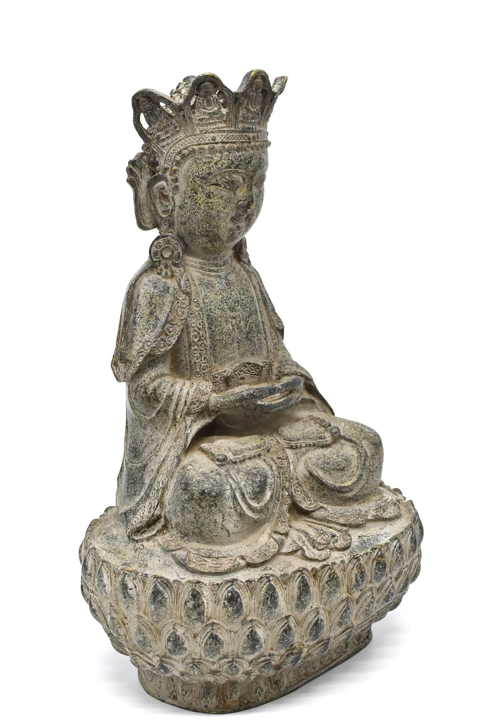 A beautiful bronze Buddha in the style of Ming dynasty Yong Le Period. Seated in dhyanasana on a double lotus base, the broad face with a serene expression, almond-shaped downcast eyes beneath high arched brows above pursed lips, all flanked by long