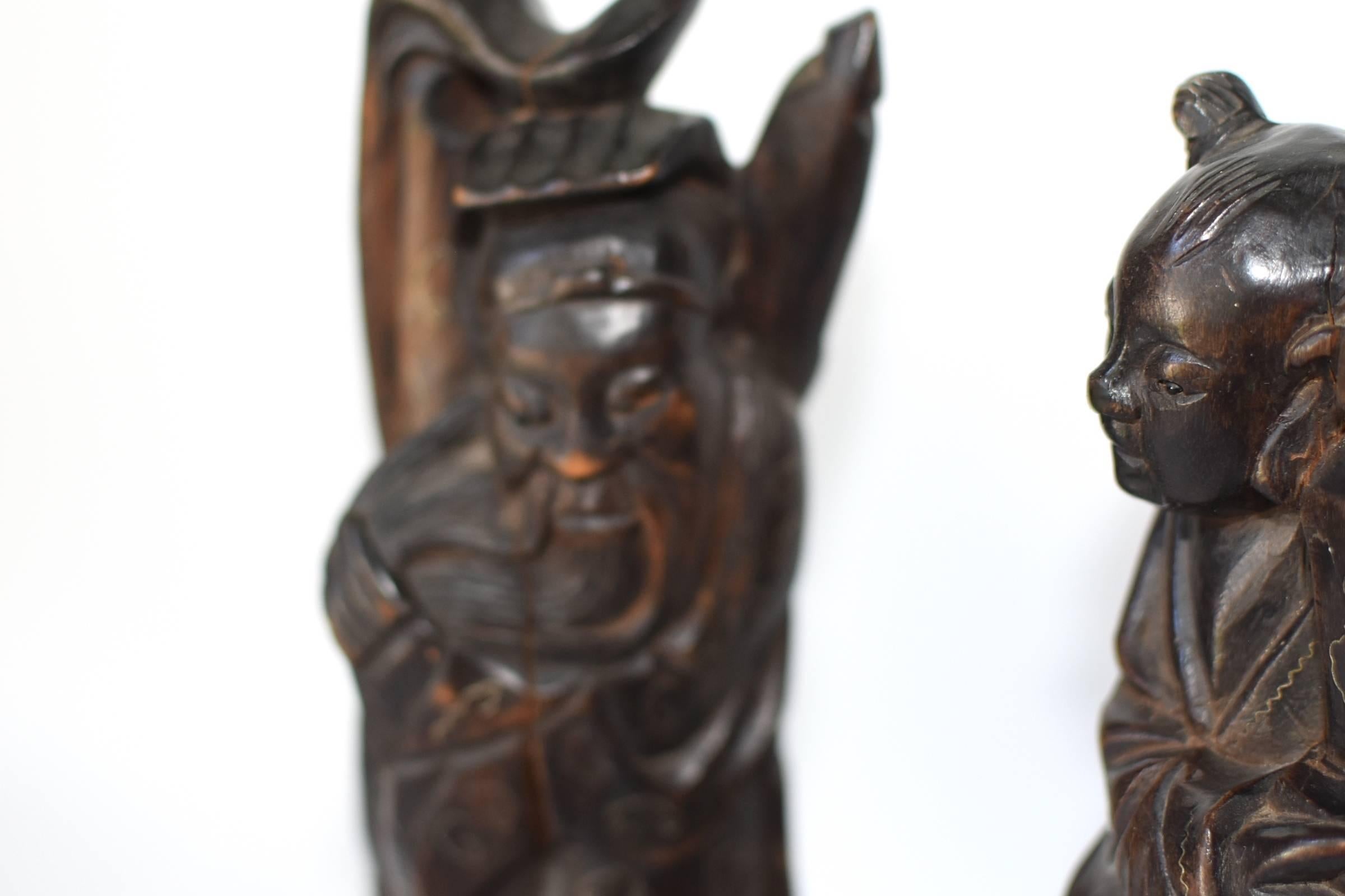 Pair of beautiful, hand-carved immortals. They bring blessings to our life in their own ways, to the elder good health and longevity, to the younger joy and music. The facial features are vivid and realistic. Beautiful silver inlay in the shape of