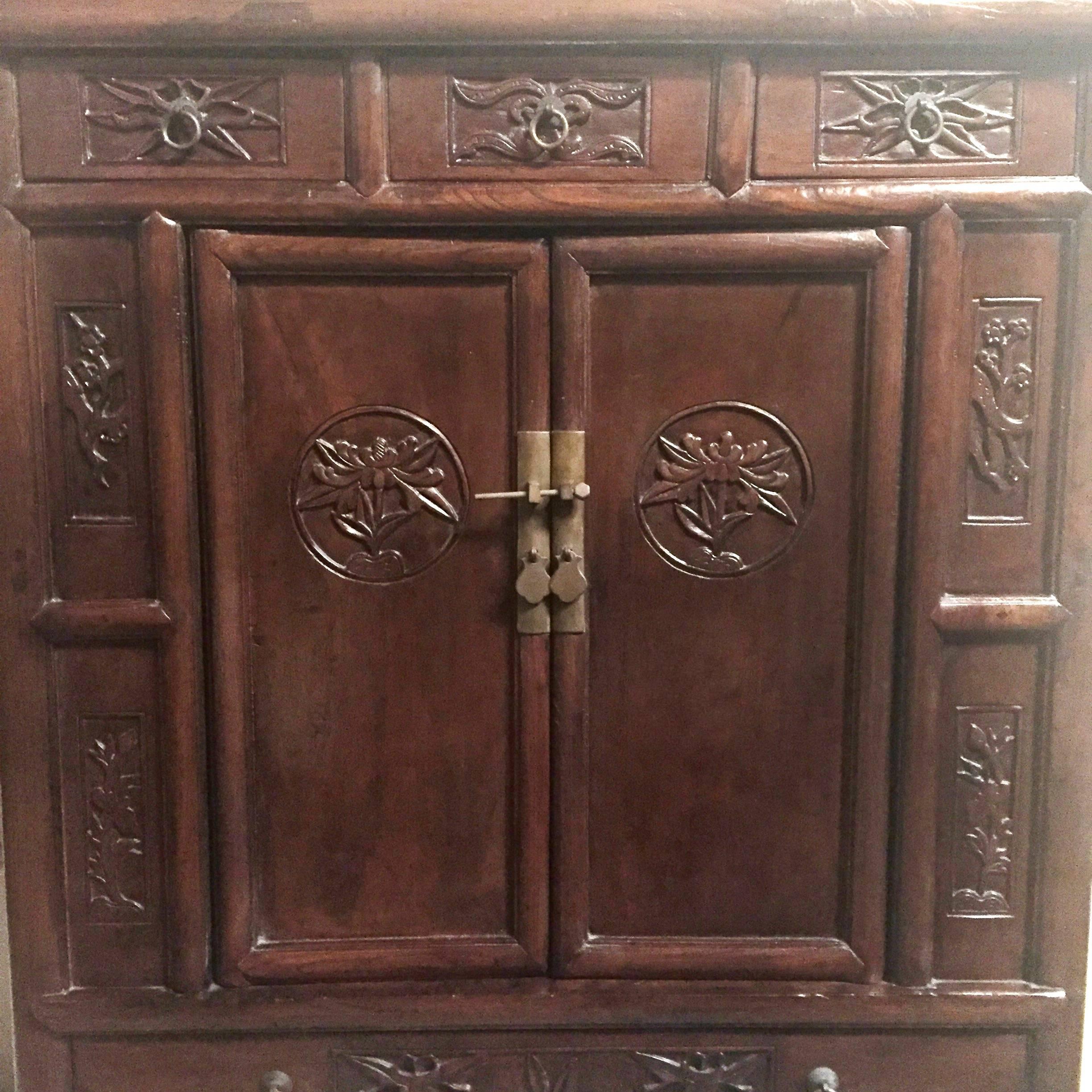 This special chest dates back to 19th century. Its use of wood, construction and overall style reflect its strong northern Chinese influence. The featured flower, peony, can be found on the doors. They symbolize prosperity. The side panels are