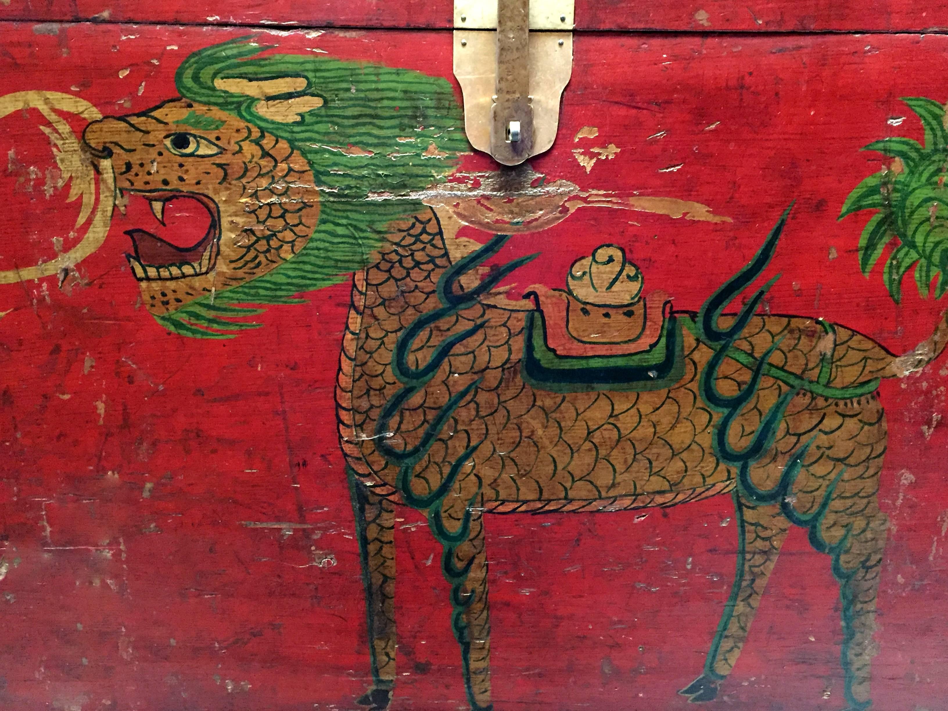 The fantastic Tibetan trunk features a single Qi Lin, the mythical animal that was believed to bring good fortune, children and prosperity. Completely hand-painted with the most charming, tribal, folk artsy approach, this trunk employs splendid