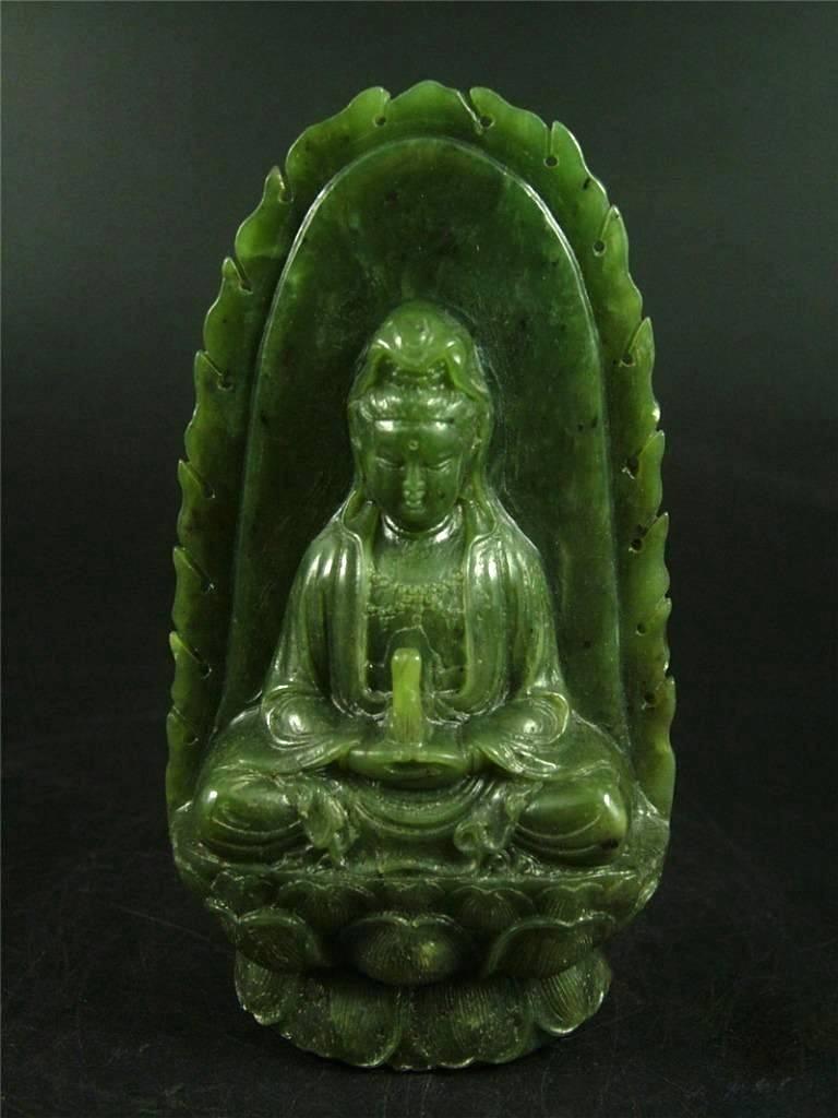 A beautiful statue of Kwan Yin in green Jade.

The goddess of compassion, Kwan Yin, is sitting on a double lotus pedestal in meditation position. She is holding a bottle in hands before her chest. The bottle contains willow water, according to