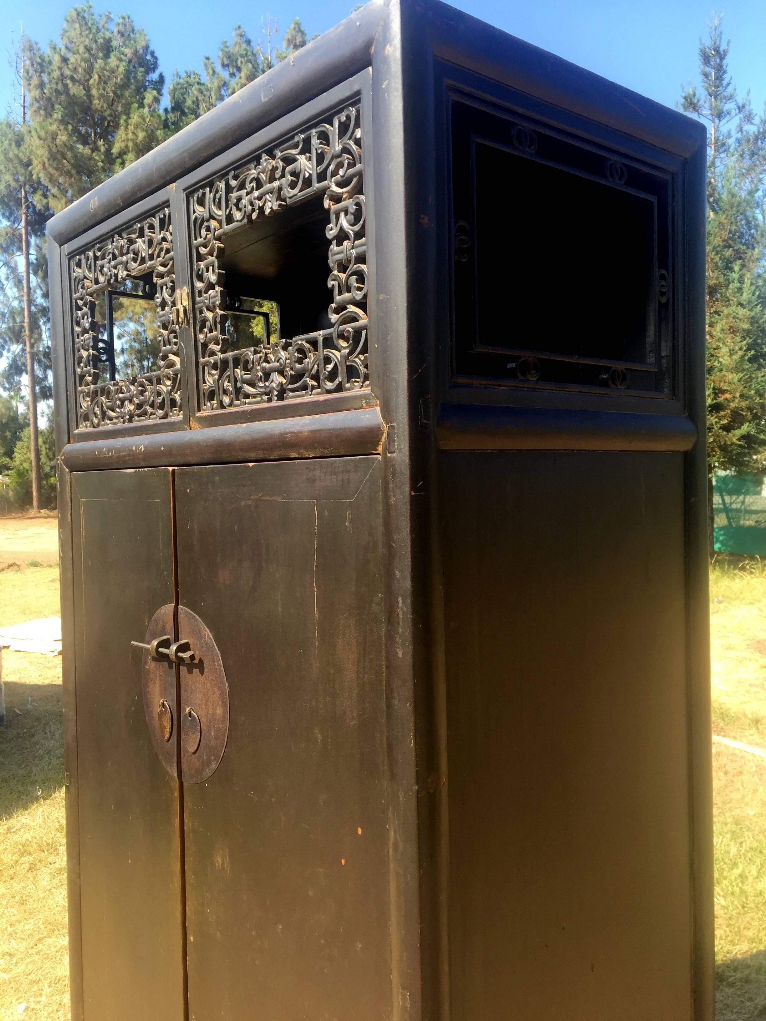 A 19th century scholar's chest from southern China. A scholar's cabinet is a highly sophisticated piece that combines the simply elegance of Ming furniture and Qin dynasty's taste for elaboration. The open air top section features window like,