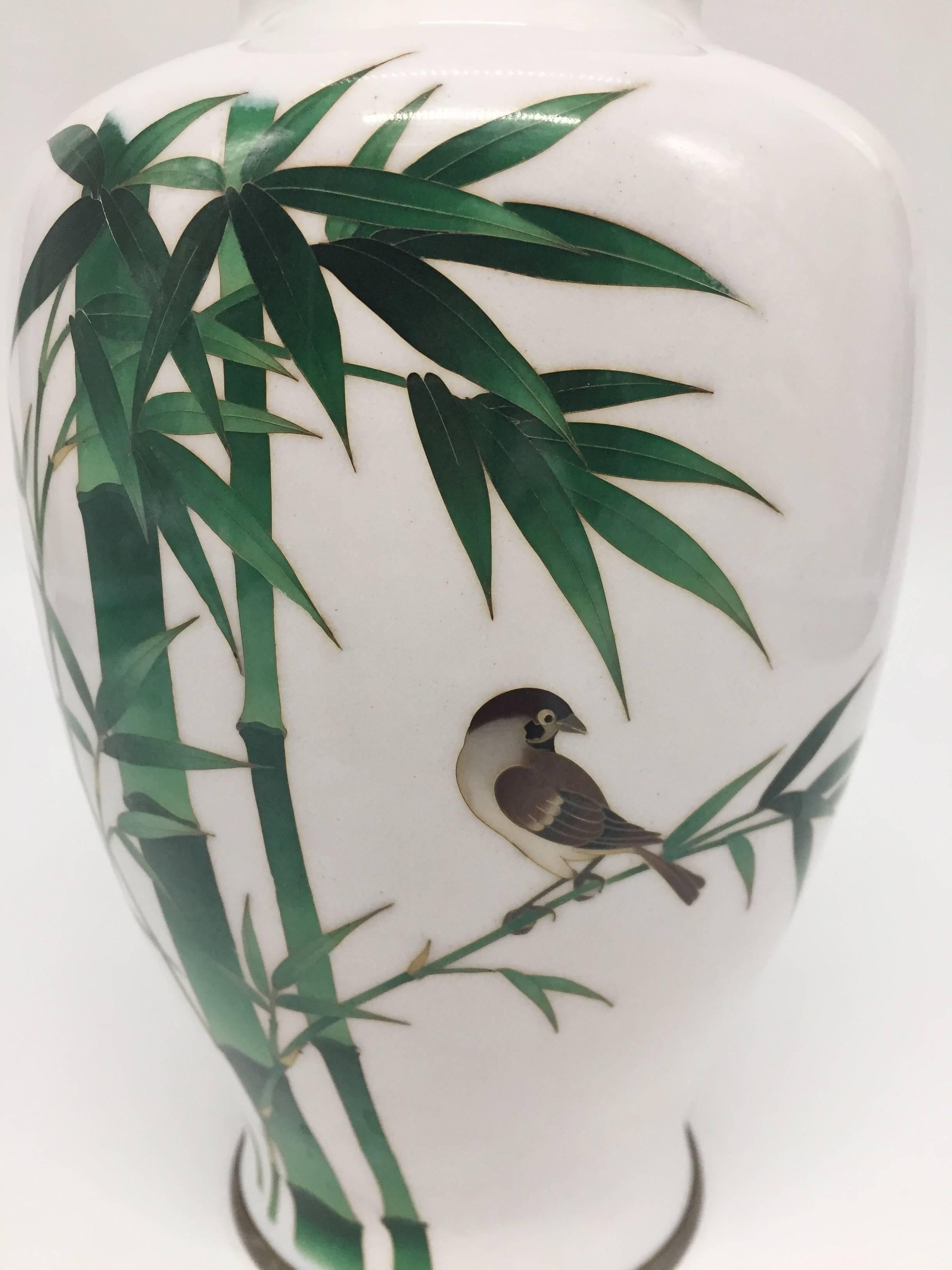 Beautiful vase in near perfect condition. Signed with the Ando mark at the base.

Featuring verdant green bamboo and a graceful bird, the vase has elegant lines, perfect proportions and the finest finish. The cloisonne work is understated and