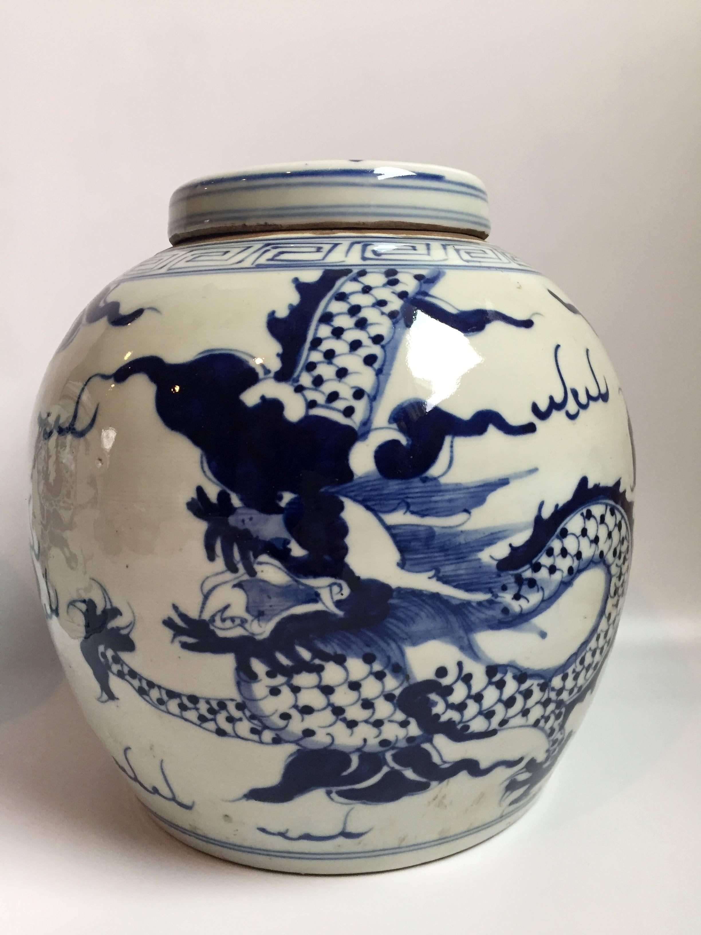 Pair of blue and white ginger jar, 20th Century, Chinese. The image is of a dragon chasing after a fire ball. This beloved image symbolizes good fortune and success. The blue and white is a classic color that is timeless. The colors on these pieces