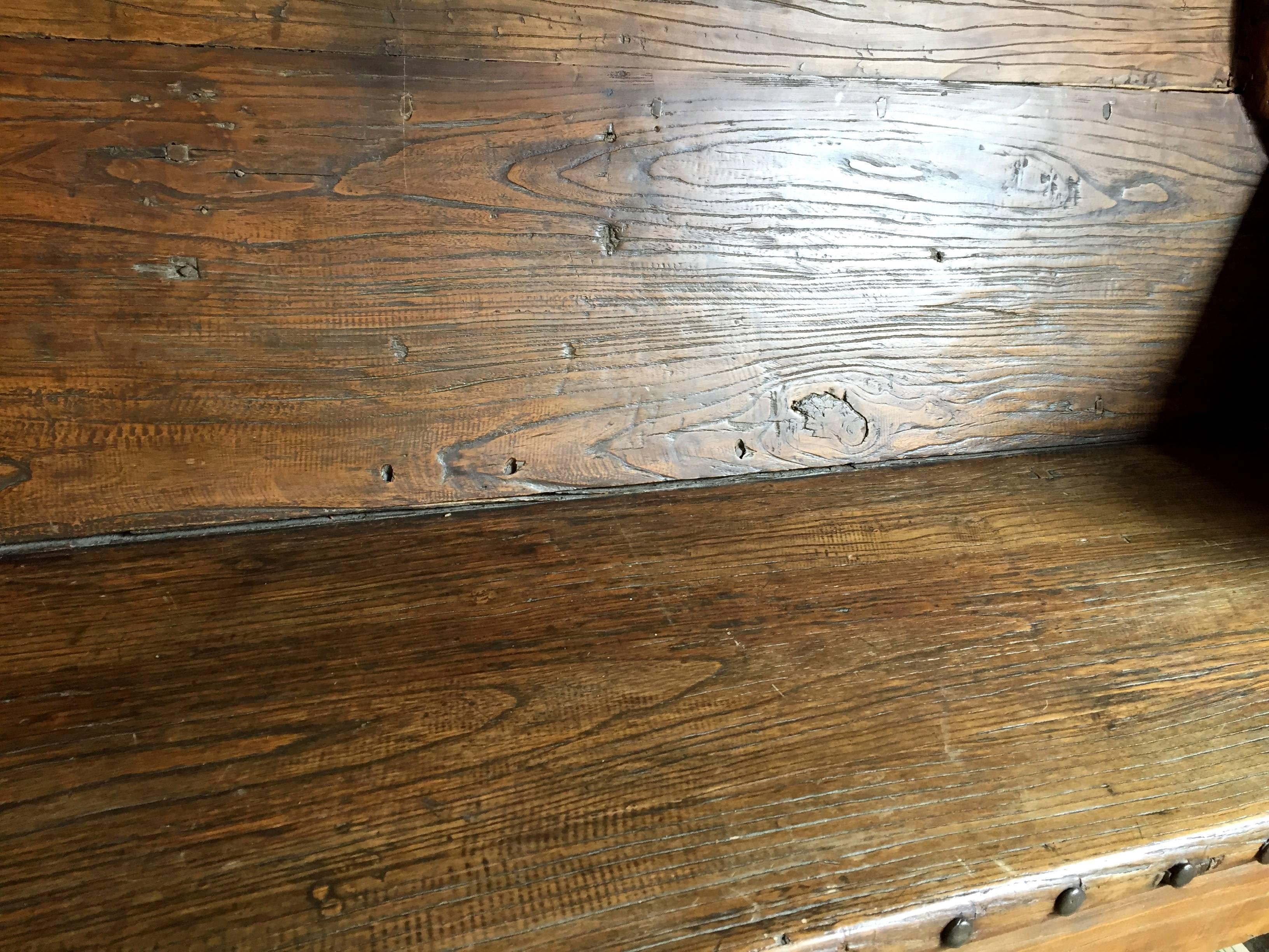 A substantial rustic bench. 

This one of a kind bench is made of old jujube logs. Jujube, with its dense, heavy substance and beautiful, unique lumps and knots in appearance, is highly valued in northern China for making substantial furniture.