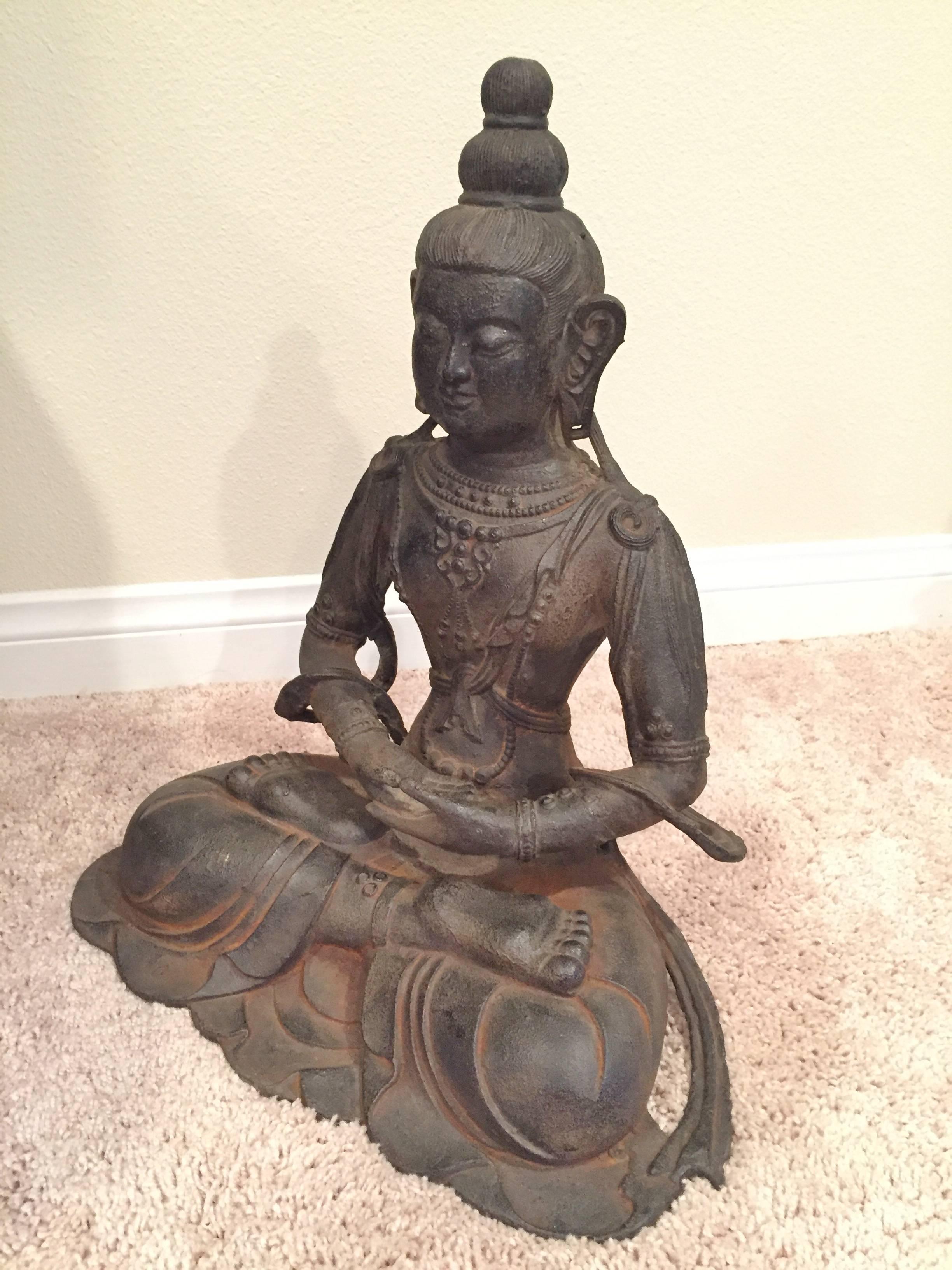 A very large iron Buddha statue. 

This is a very fine piece that is incredibly detailed. Buddha has beautiful facial features, fingers and toes. The robe shows fluid folds and sashes. A decorated bodice features necklaces and flowers. 

This piece