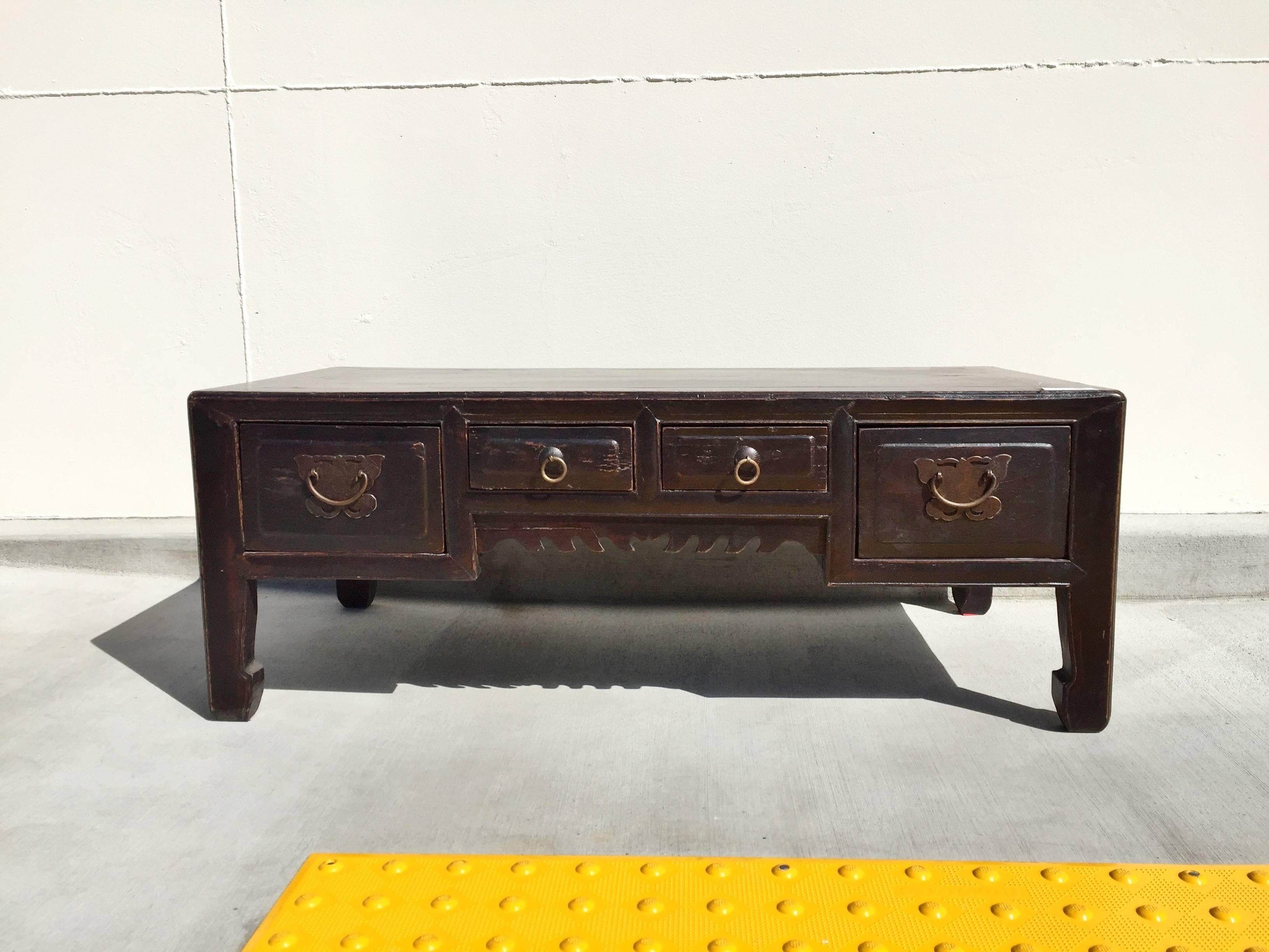19th century Chinese low table features four full length drawers adorned with bronze butterfly hardware. Beautiful hoof legs give the nod to Ming dynasty.

Perfect coffee table or as a stand for your sculpture or statues.

Solid wood. Tenons and