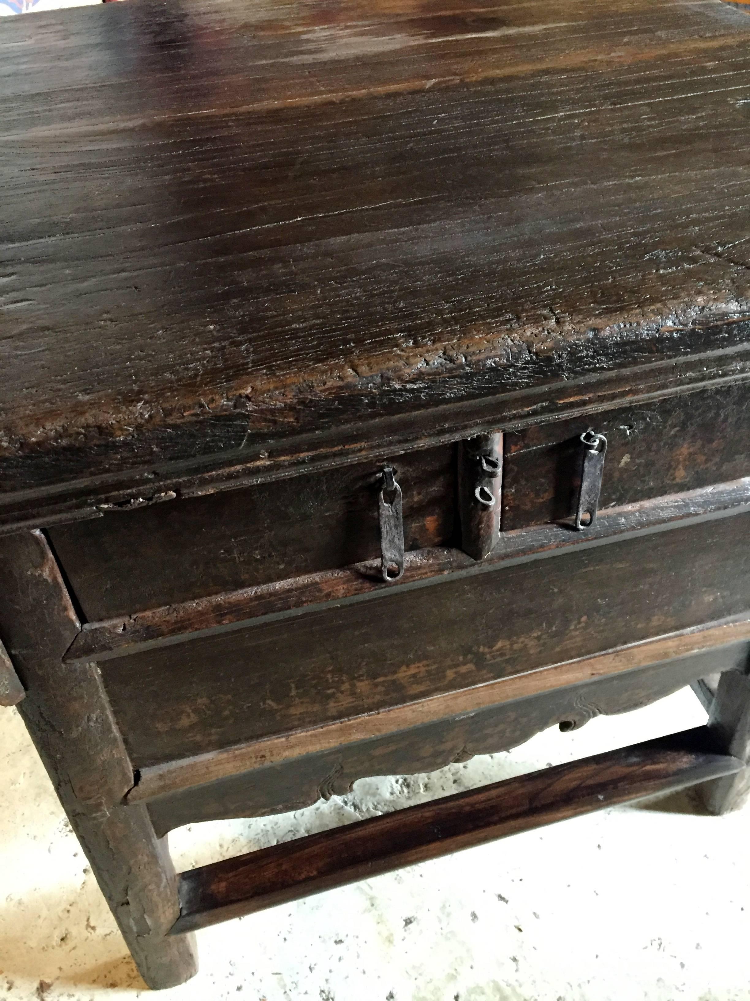 This is a very special, all original country table. The top is almost a square, made with a chunk of solid wood. The table is very heavy and substantial as only solid woods and used.

Two full length drawers provide ample storage and hide a secret