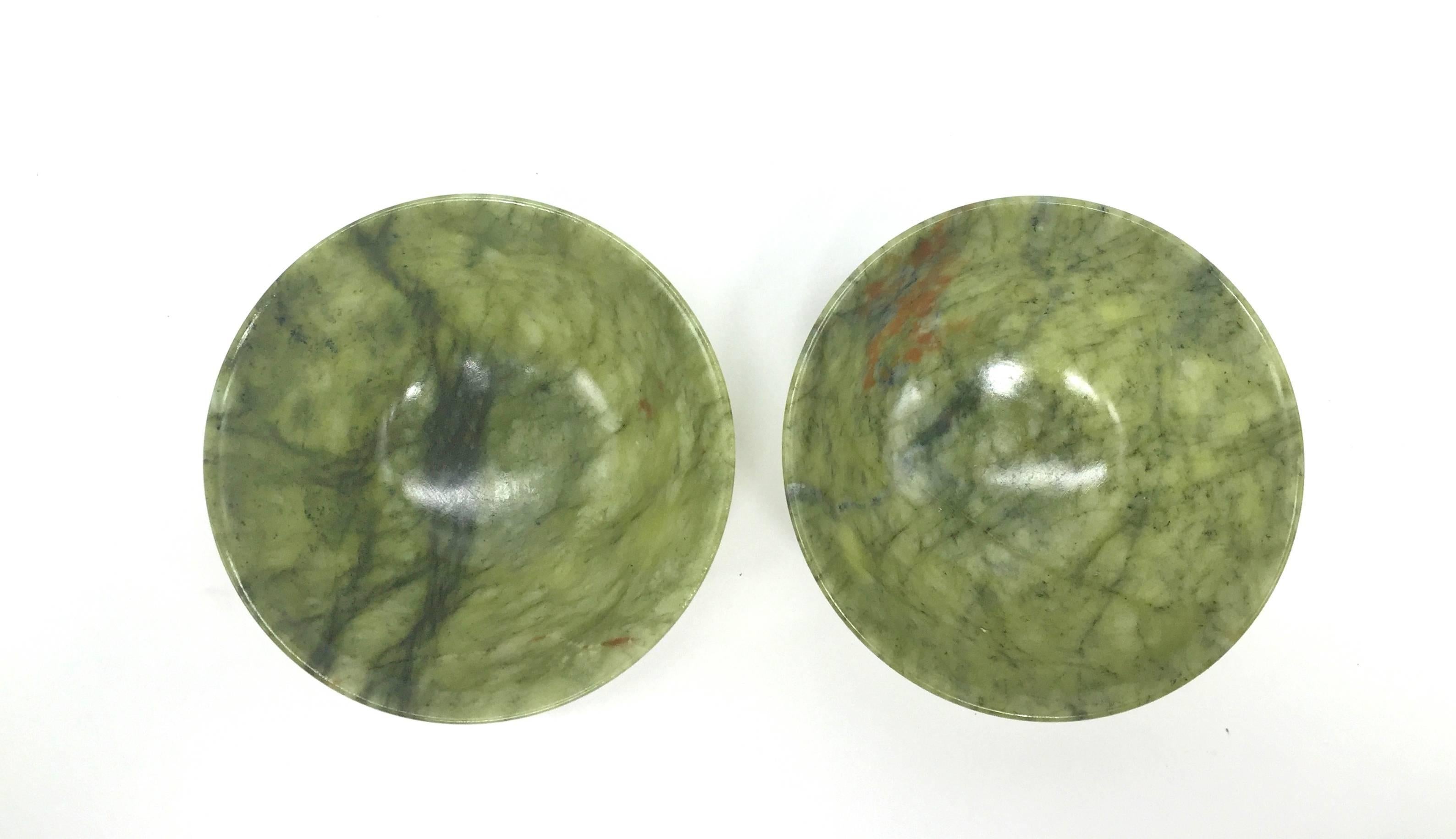 A pair of large serpentine bowls/cups. 

These beautiful bowls/cups have graceful lines. The natural inclusions are intriguing and unique. Under the light, the cups turn translucent, demonstrating the mesmerizing nature of the stone.

They are the