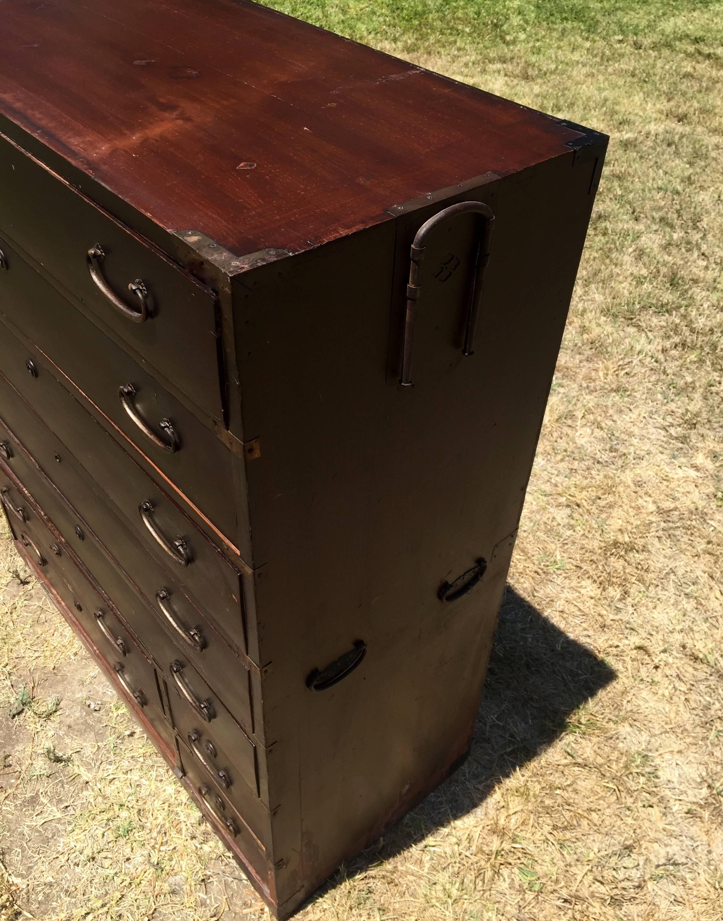 A vintage Japanese Tansu with nine elegant drawers.

The Meiji period piece has full capacity drawers and beautiful hardware. This versatile chest can be used in many areas of your home, both for storage or as a stand.

Solid wood.