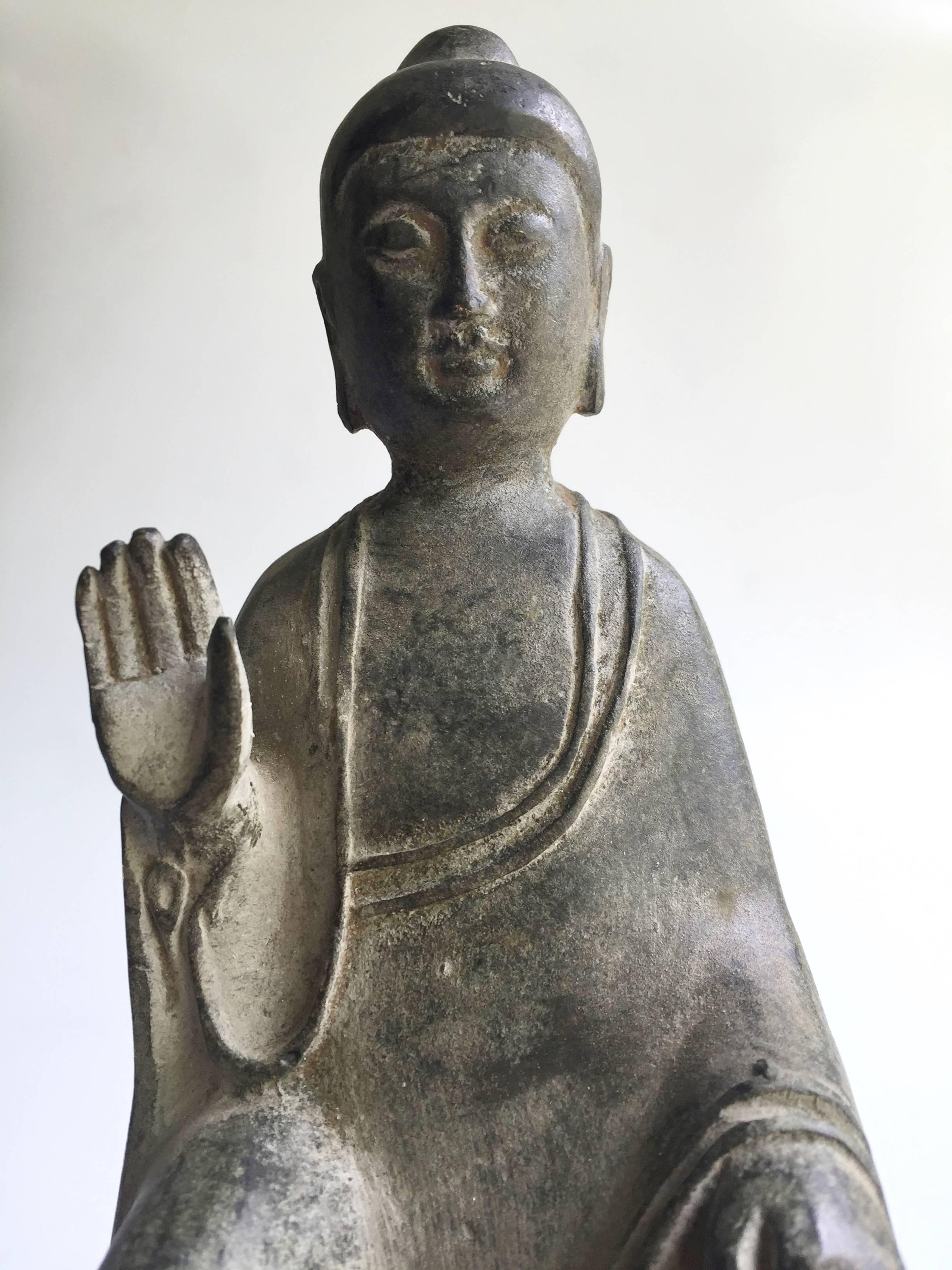 This is a beautiful antique bronze piece that depicts Buddha with the No-Fear Mudra. The lines are fluid and elegant, his face is soft and expressions calm. Both his feet rest on lion patterned stumps, which symbolize protection and guidance.